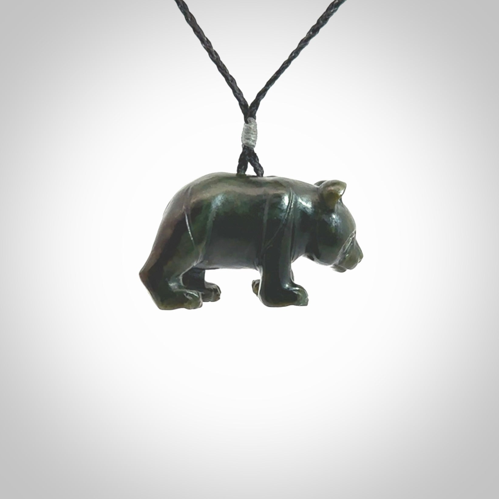 This picture shows a pendant that we designed in New Zealand jade. It is a little green bear that has a walking stance and is carved in detail. A really attractive and eye-catching piece of handmade jewellery. The cord is hand plaited braid and the length can be adjusted.