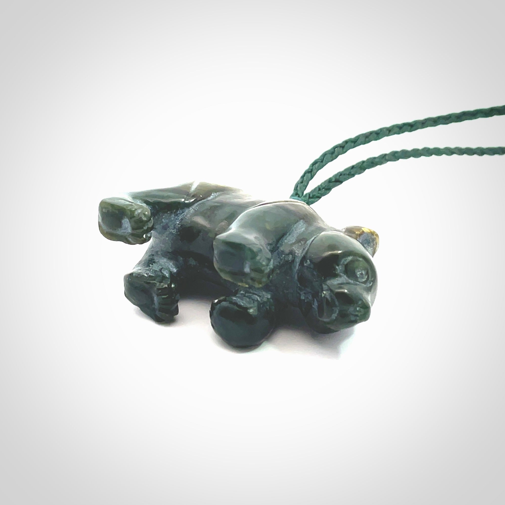 This picture shows a pendant that we designed in New Zealand jade. It is a little green bear that has a walking stance and is carved in detail. A really attractive and eye-catching piece of handmade jewellery. The cord is hand plaited braid in manuka green and the length can be adjusted.