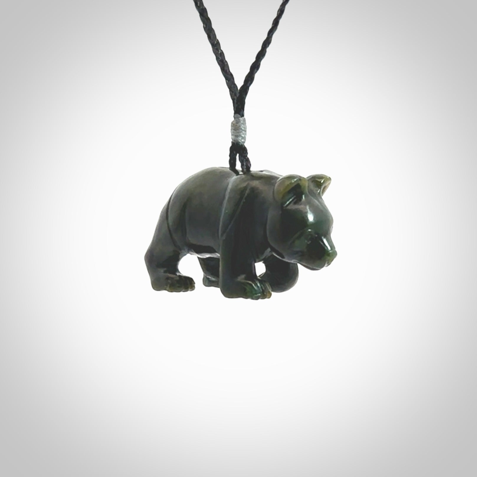 This picture shows a pendant that we designed in New Zealand jade. It is a little green bear that has a walking stance and is carved in detail. A really attractive and eye-catching piece of handmade jewellery. The cord is hand plaited braid and the length can be adjusted.