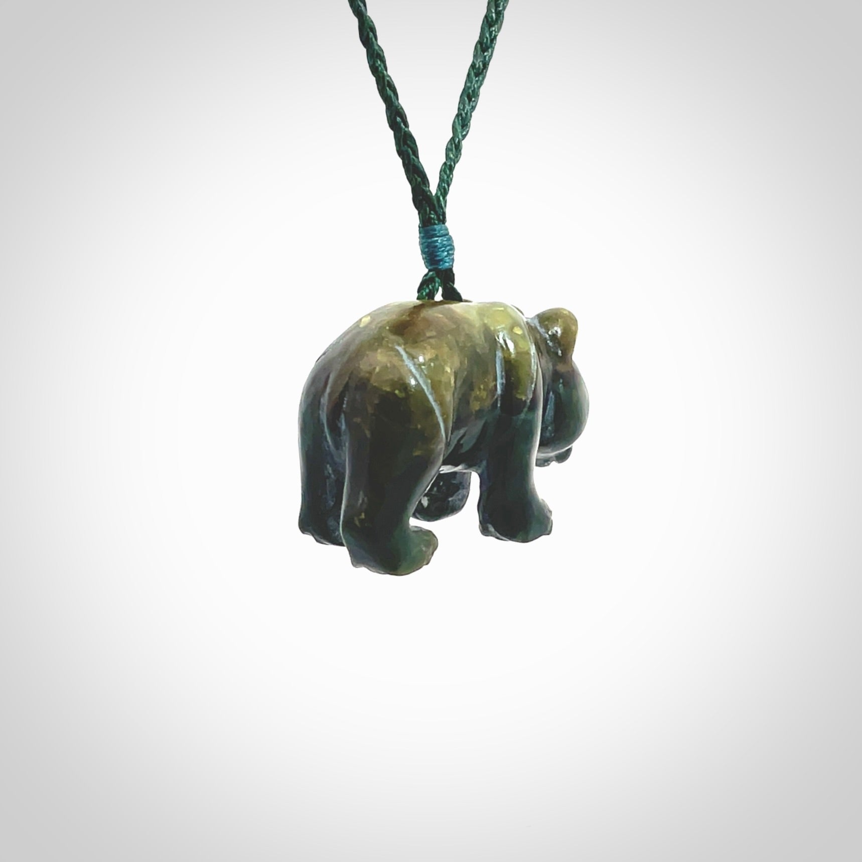 This picture shows a pendant that we designed in New Zealand jade. It is a little green bear that has a walking stance and is carved in detail. A really attractive and eye-catching piece of handmade jewellery. The cord is hand plaited braid in manuka green and the length can be adjusted.