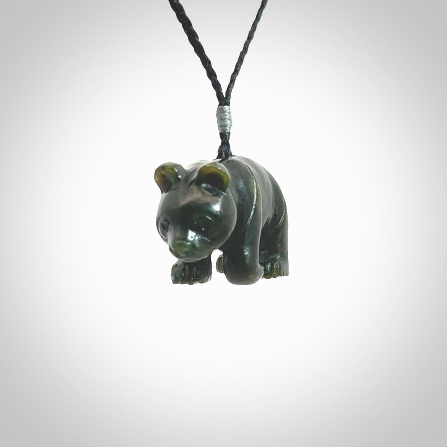 This picture shows a pendant that we designed in New Zealand jade. It is a little green bear that has a walking stance and is carved in detail. A really attractive and eye-catching piece of handmade jewellery. The cord is hand plaited braid and the length can be adjusted.