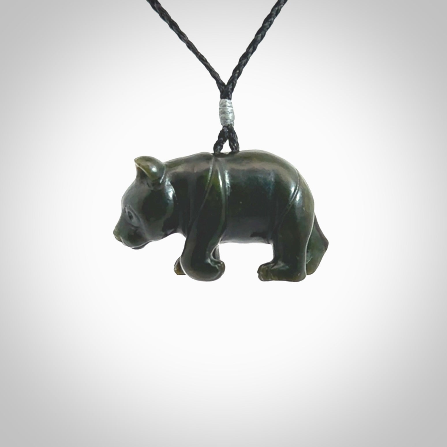 This picture shows a pendant that we designed in New Zealand jade. It is a little green bear that has a walking stance and is carved in detail. A really attractive and eye-catching piece of handmade jewellery. The cord is hand plaited braid and the length can be adjusted.