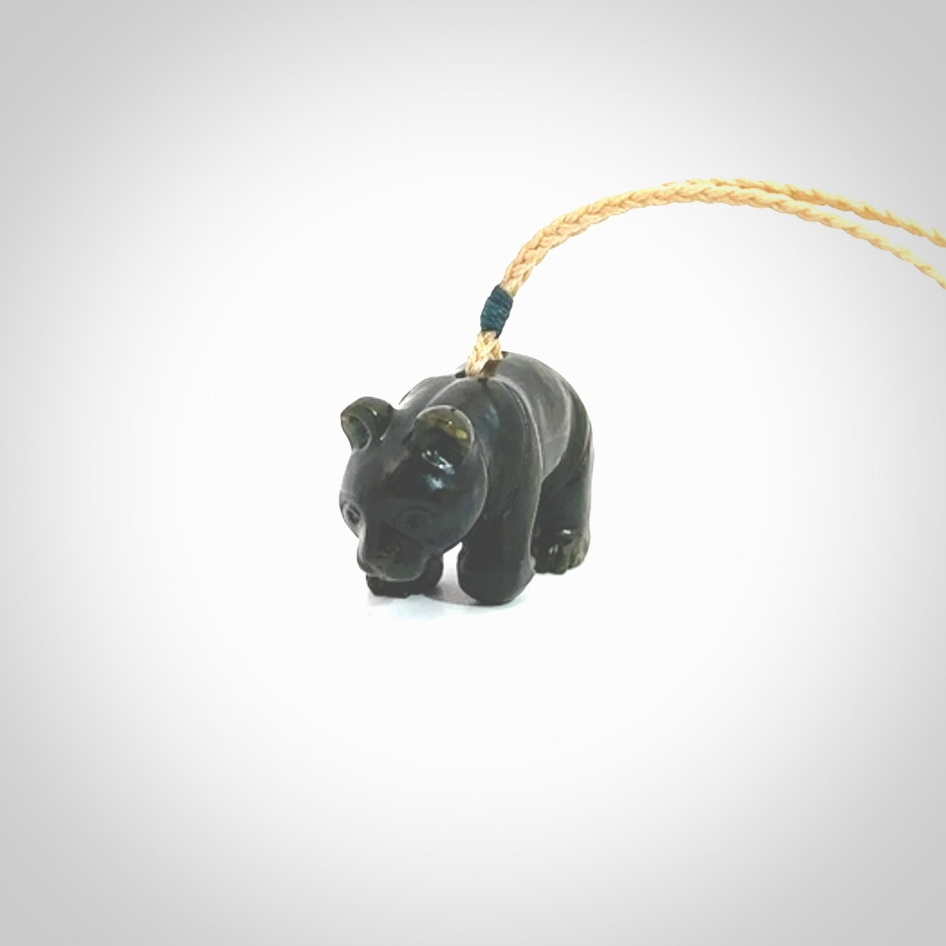 This picture shows a pendant that we designed in New Zealand jade. It is a little green bear that has a walking stance and is carved in detail. A really attractive and eye-catching piece of handmade jewellery. The cord is hand plaited braid and the length can be adjusted.