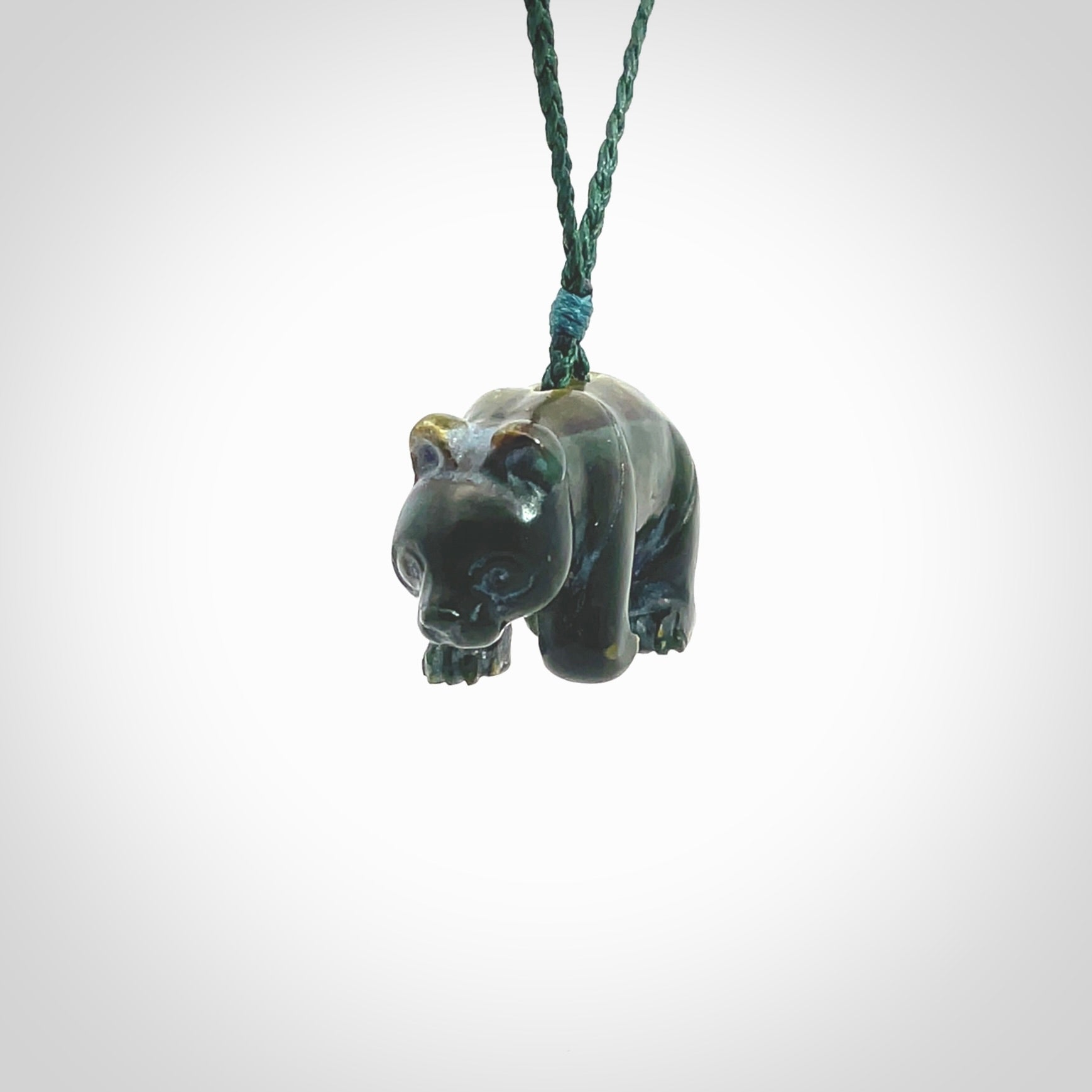 This picture shows a pendant that we designed in New Zealand jade. It is a little green bear that has a walking stance and is carved in detail. A really attractive and eye-catching piece of handmade jewellery. The cord is hand plaited braid in manuka green and the length can be adjusted.