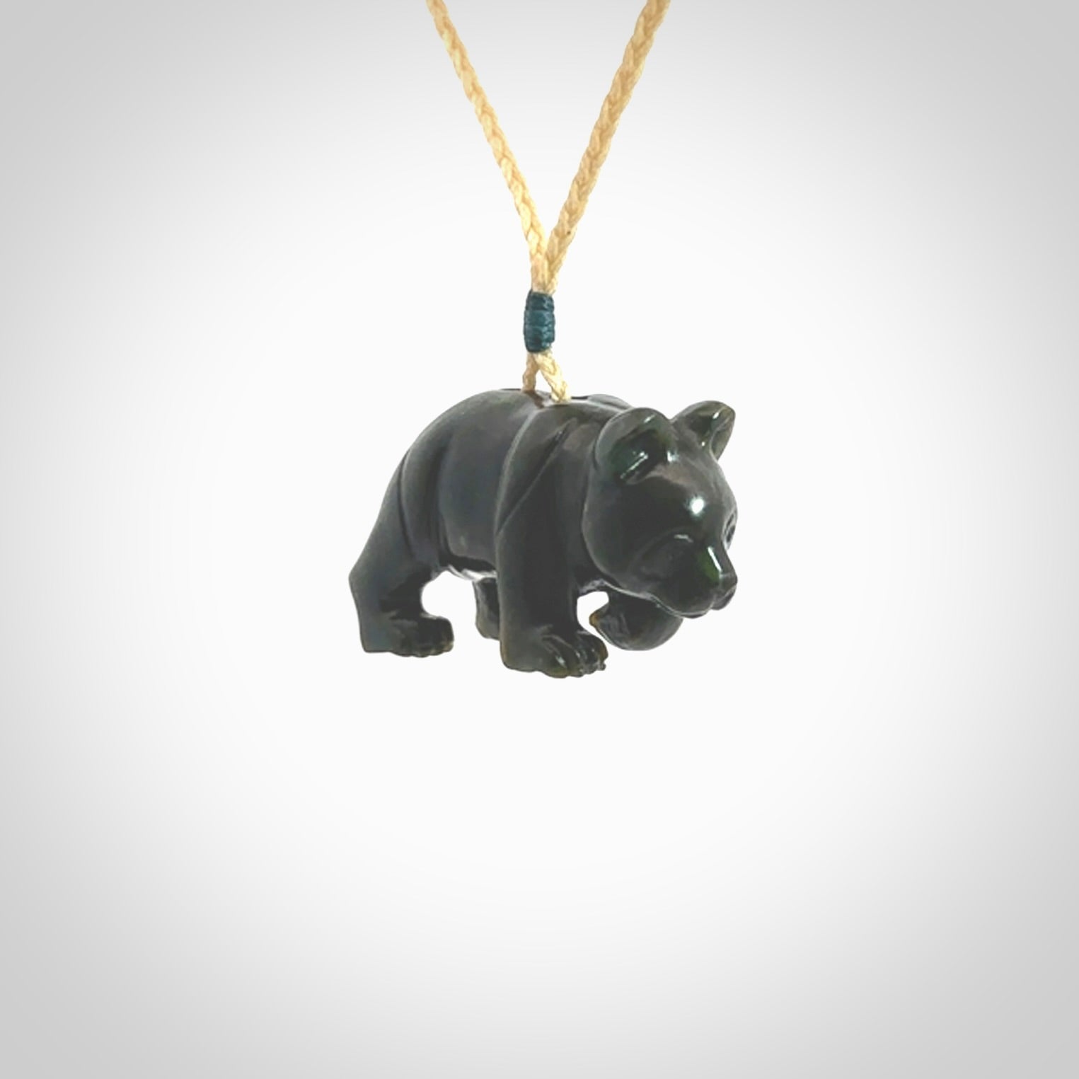 This picture shows a pendant that we designed in New Zealand jade. It is a little green bear that has a walking stance and is carved in detail. A really attractive and eye-catching piece of handmade jewellery. The cord is hand plaited braid and the length can be adjusted.