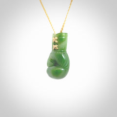 Hand carved boxing glove made from New Zealand Jade. The cord is adjustable so that you can wear this where it suits you best. We have bound these with a Oat coloured cord which contrasts with the green of the jade glove. The cost of shipping worldwide is included in the price.