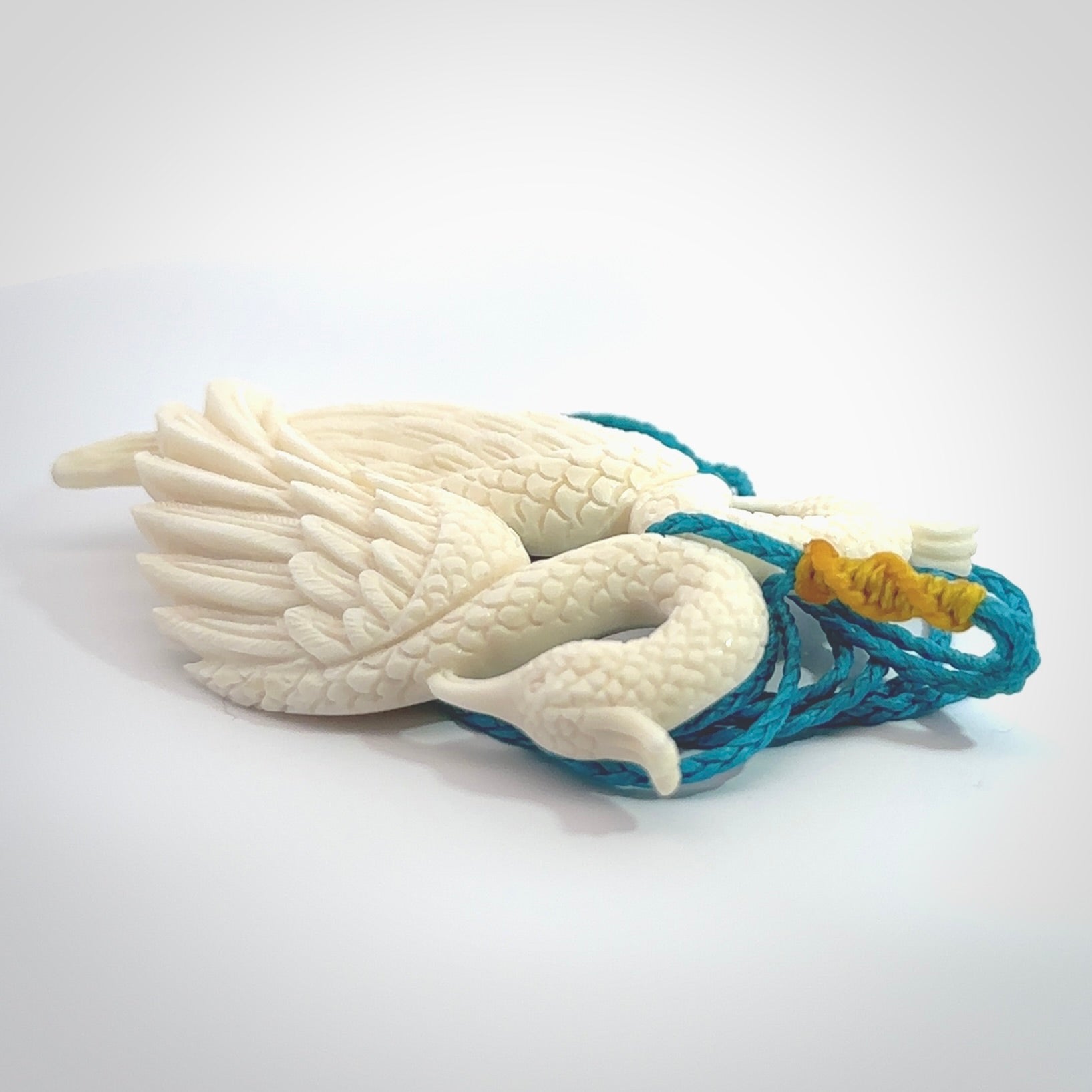 Hand carved stellar intricate double peacock carving. A stunning work of art. This pendant was hand carved in Bone. A one off peacock carving that has been hand crafted to be worn. Delivered with a paradise blue adjustable cord.