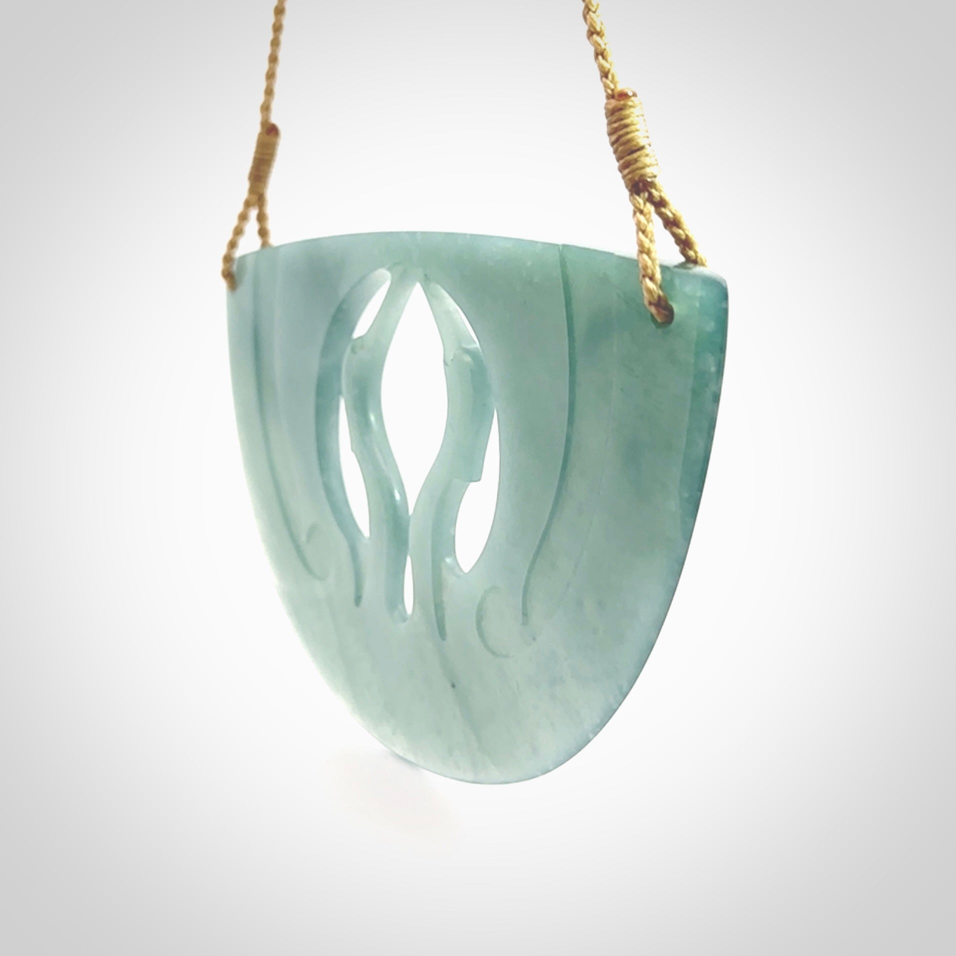 This large piece is a hand carved double Kotuku (white heron) bird breastplate pendant. Kerry carved this from Guatemalan Jade. It is a gorgeous blue colour and is an artistic piece of jewellery. Hand made by Kerry Thompson and delivered to you in a kete pouch.