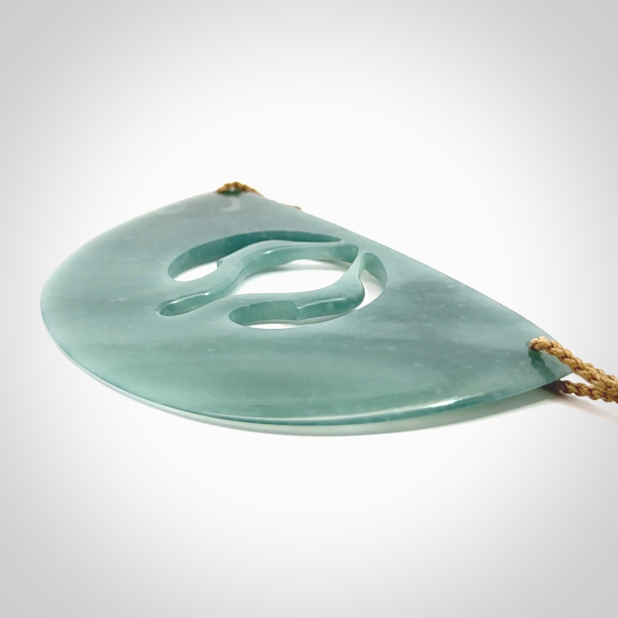 This large piece is a hand carved double Kotuku (white heron) bird breastplate pendant. Kerry carved this from Guatemalan Jade. It is a gorgeous blue colour and is an artistic piece of jewellery. Hand made by Kerry Thompson and delivered to you in a kete pouch.