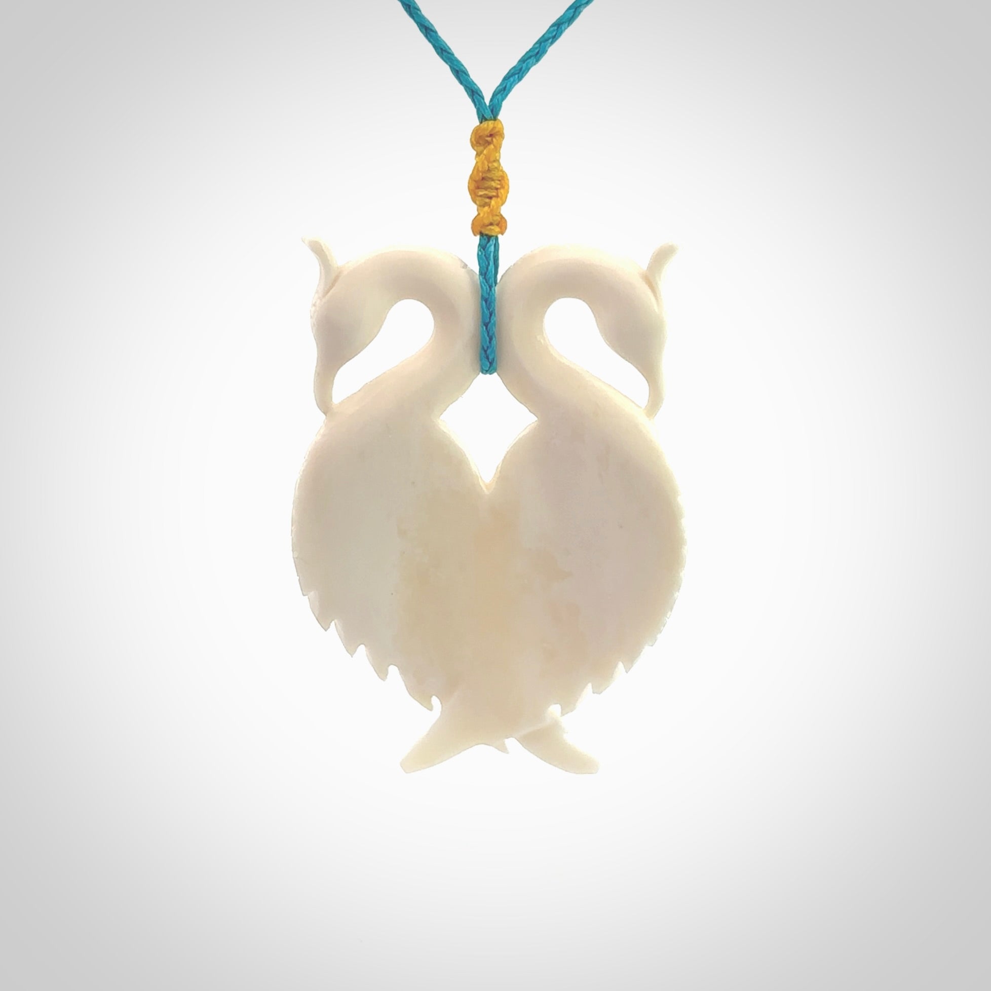 Hand carved stellar intricate double peacock carving. A stunning work of art. This pendant was hand carved in Bone. A one off peacock carving that has been hand crafted to be worn. Delivered with a paradise blue adjustable cord.