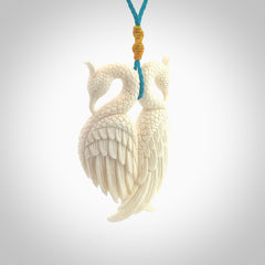 Hand carved stellar intricate double peacock carving. A stunning work of art. This pendant was hand carved in Bone. A one off peacock carving that has been hand crafted to be worn. Delivered with a paradise blue adjustable cord.