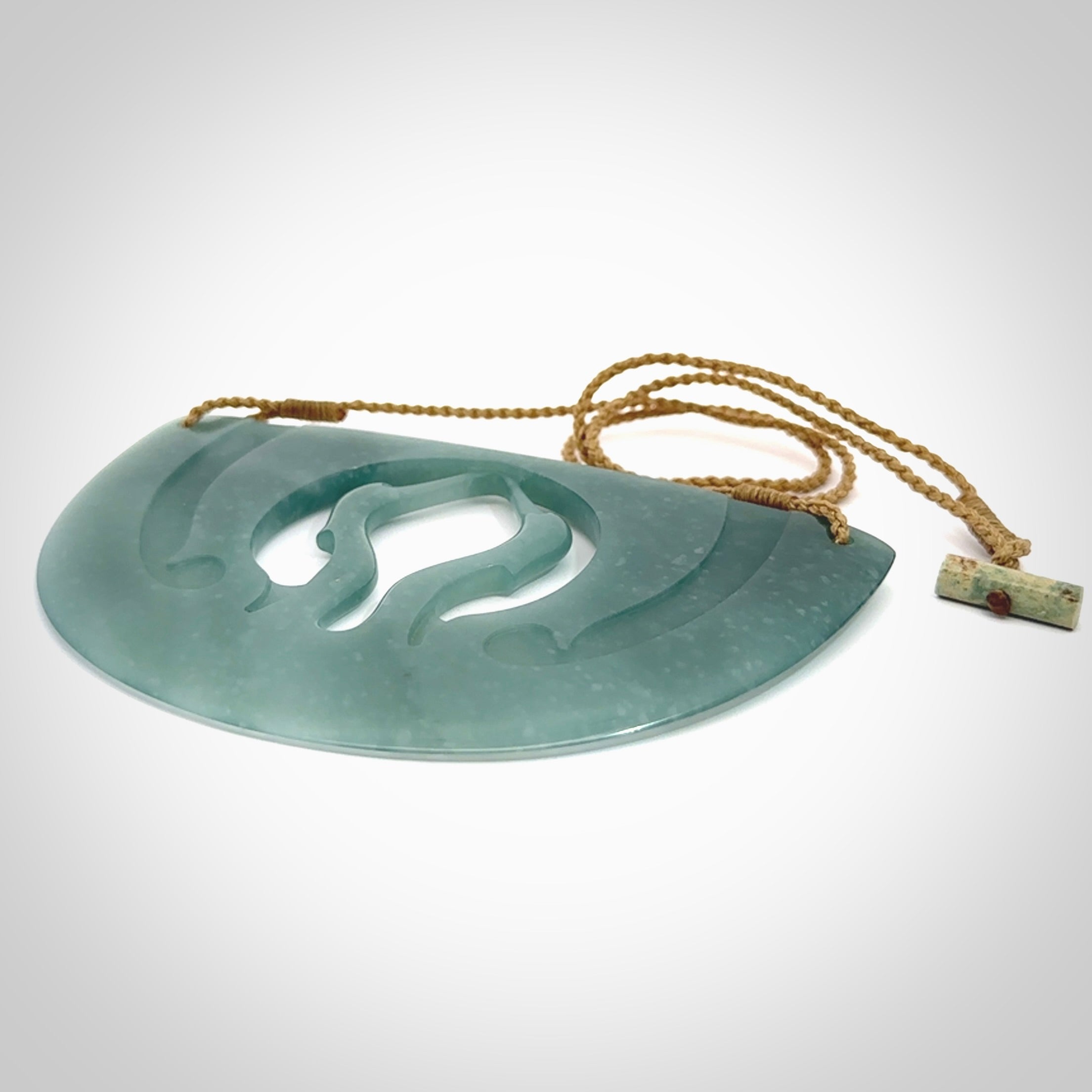 This large piece is a hand carved double Kotuku (white heron) bird breastplate pendant. Kerry carved this from Guatemalan Jade. It is a gorgeous blue colour and is an artistic piece of jewellery. Hand made by Kerry Thompson and delivered to you in a kete pouch.