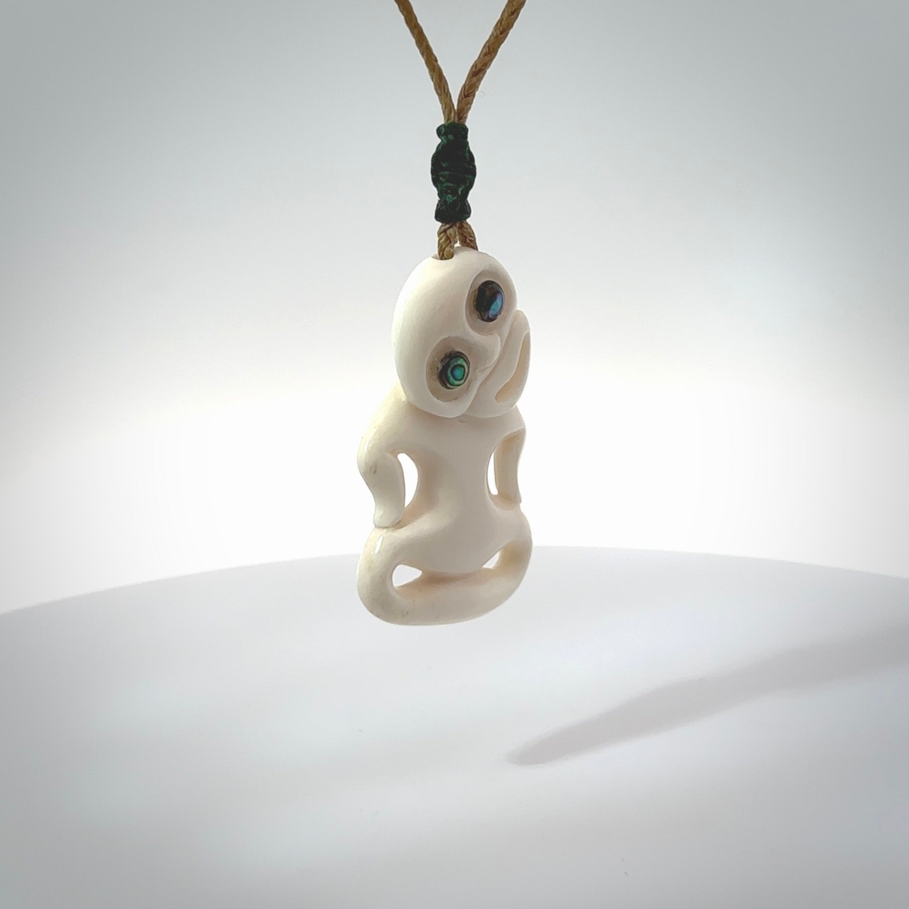 This little bone tiki has been carved to look and feel great. It has pāua shell eyes and is provided with a hand plaited cord. A gorgeous and small traditional piece that is great for children.