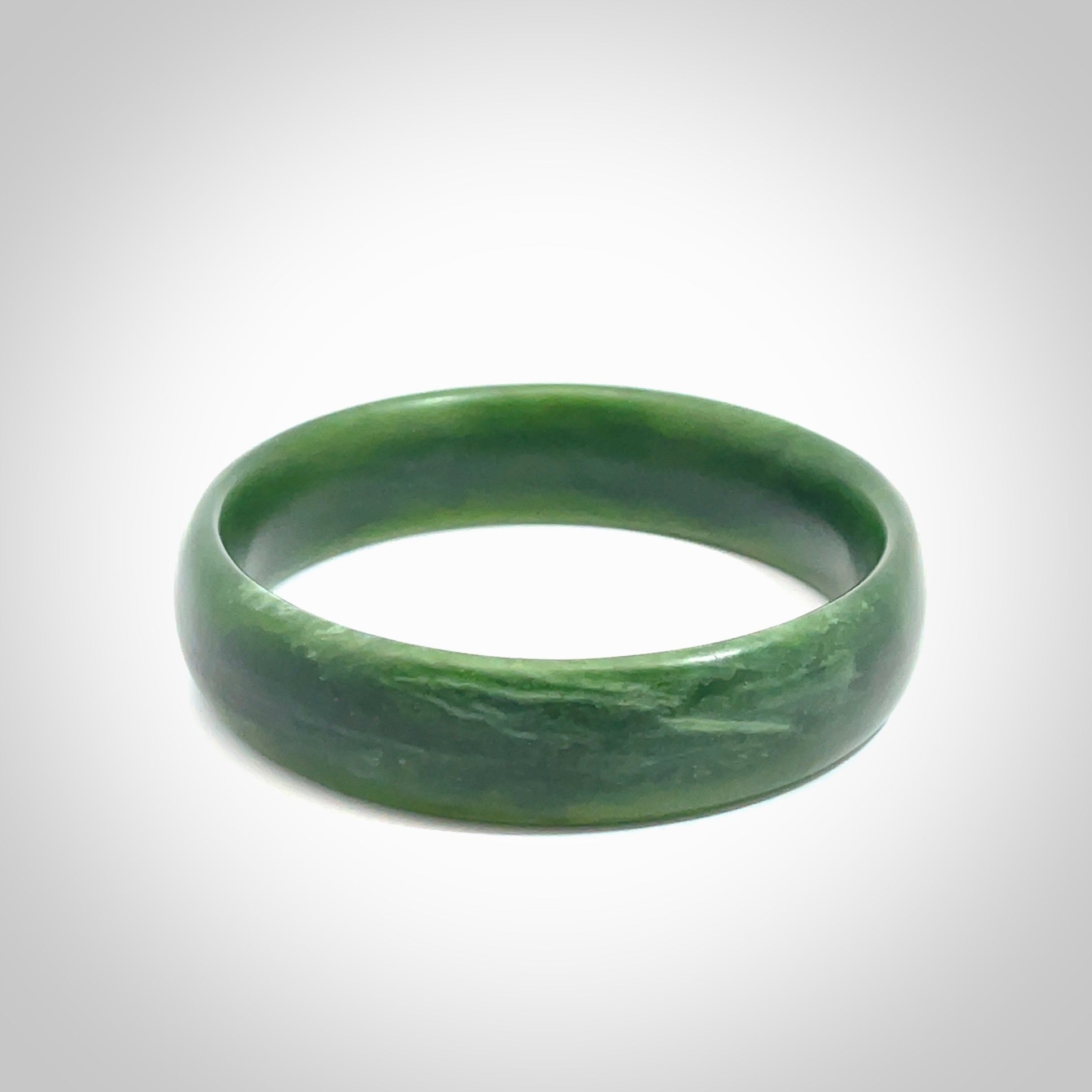 Hand carved New Zealand Jade bangle with matte finish, by Ric Moor. This is a spectacular one off, bracelet hand made in New Zealand from gorgeous Jade. Unique art to wear, delivered in a woven kete pouch. Real New Zealand Jade. Outstanding craftsmanship by New Zealand Master Carver Ric Moor.