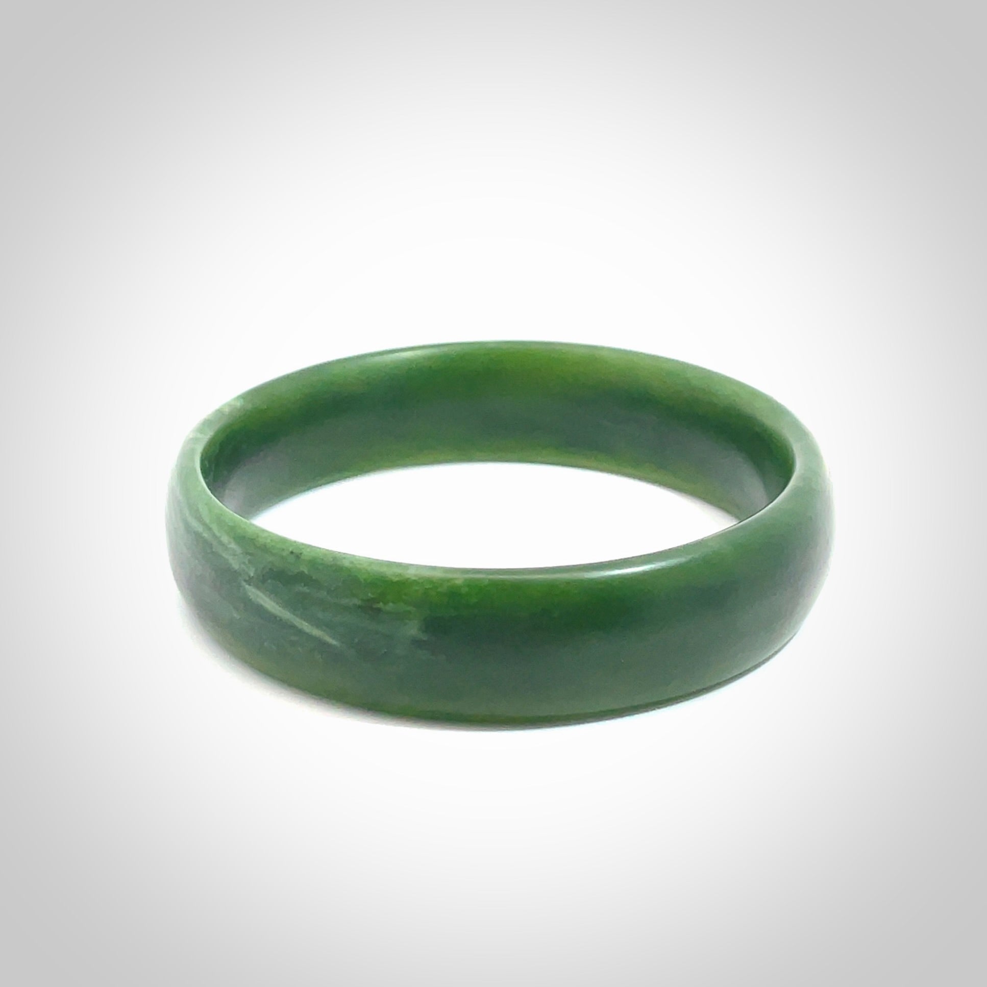 Hand carved New Zealand Jade bangle with matte finish, by Ric Moor. This is a spectacular one off, bracelet hand made in New Zealand from gorgeous Jade. Unique art to wear, delivered in a woven kete pouch. Real New Zealand Jade. Outstanding craftsmanship by New Zealand Master Carver Ric Moor.