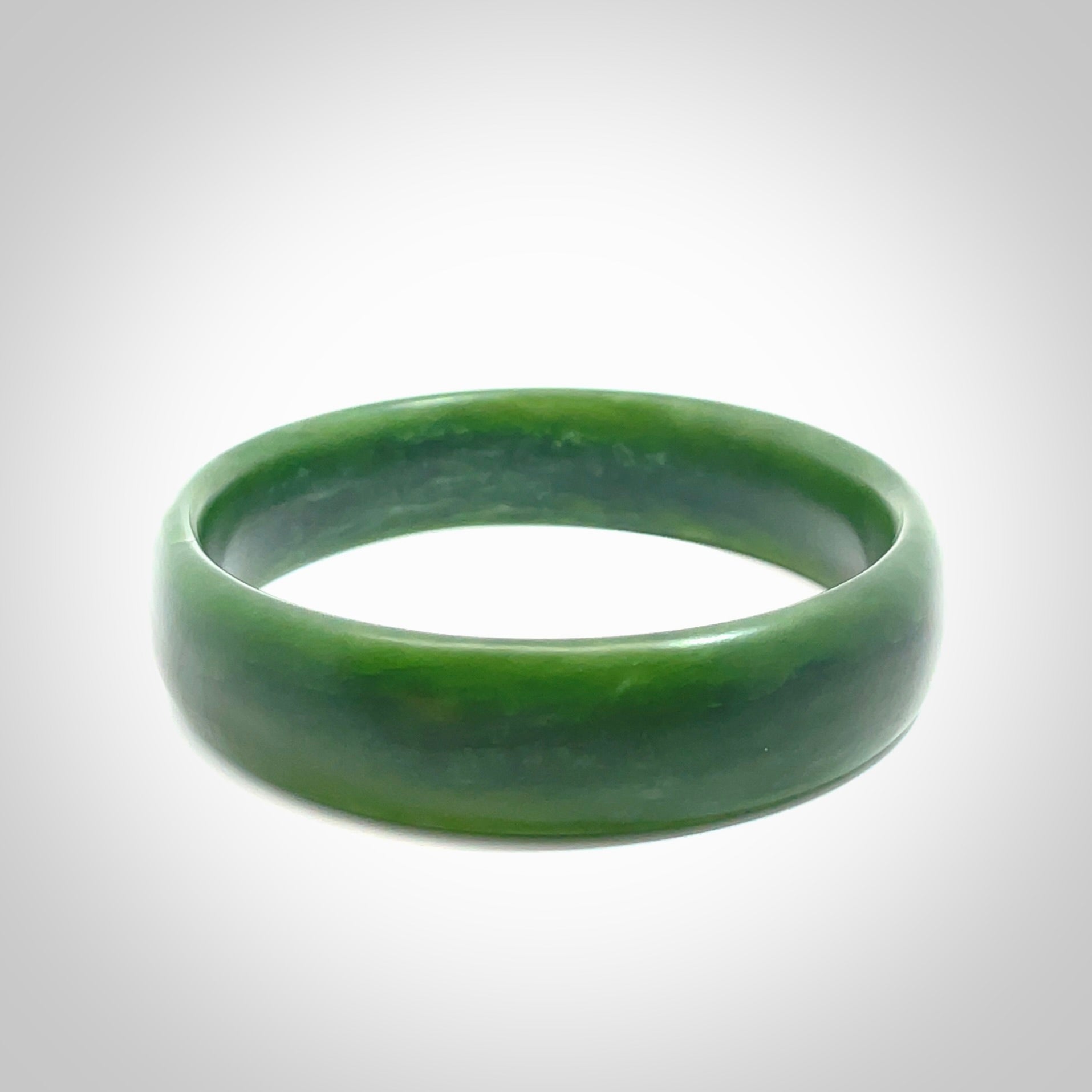 Hand carved New Zealand Jade bangle with matte finish, by Ric Moor. This is a spectacular one off, bracelet hand made in New Zealand from gorgeous Jade. Unique art to wear, delivered in a woven kete pouch. Real New Zealand Jade. Outstanding craftsmanship by New Zealand Master Carver Ric Moor.