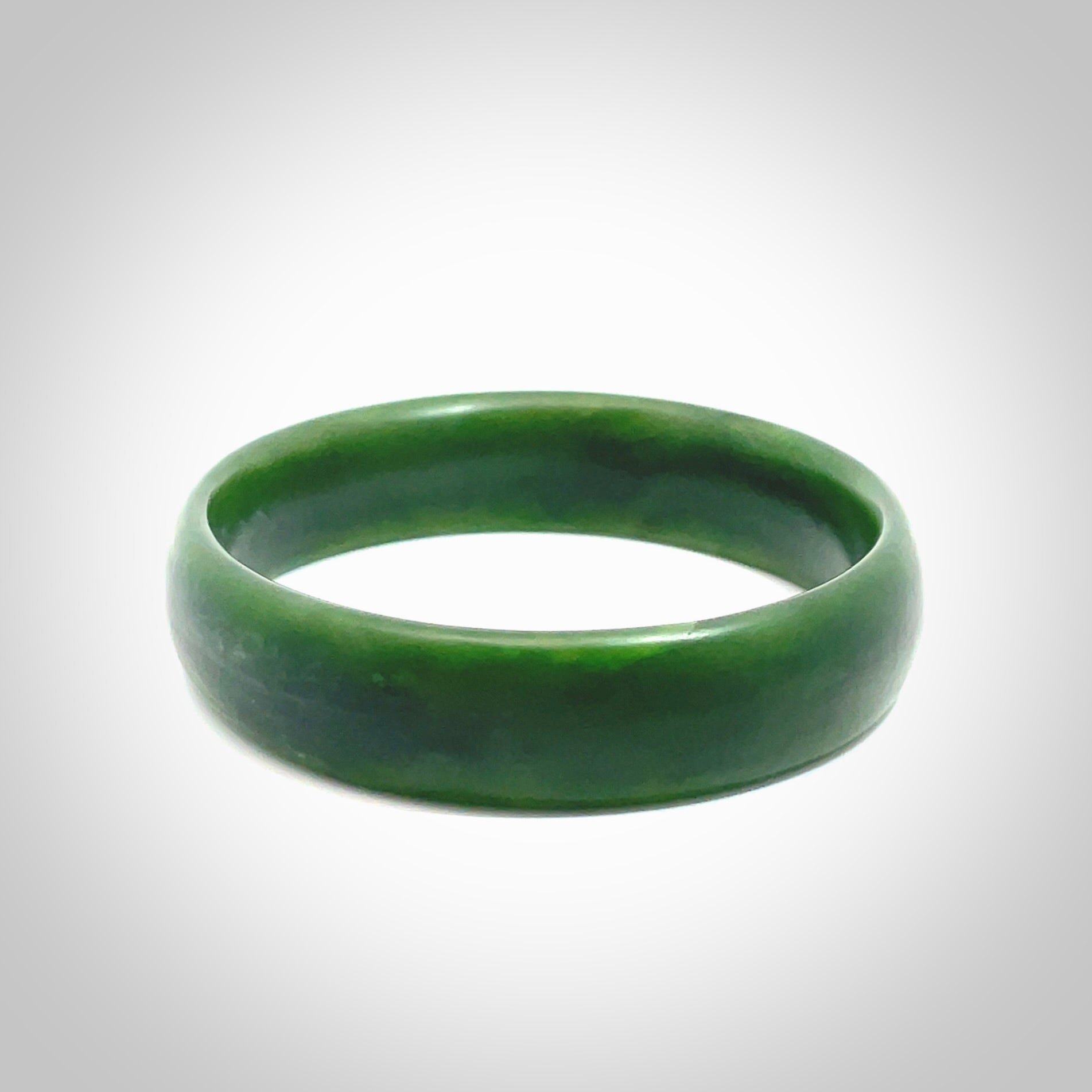 Hand carved New Zealand Jade bangle with matte finish, by Ric Moor. This is a spectacular one off, bracelet hand made in New Zealand from gorgeous Jade. Unique art to wear, delivered in a woven kete pouch. Real New Zealand Jade. Outstanding craftsmanship by New Zealand Master Carver Ric Moor.