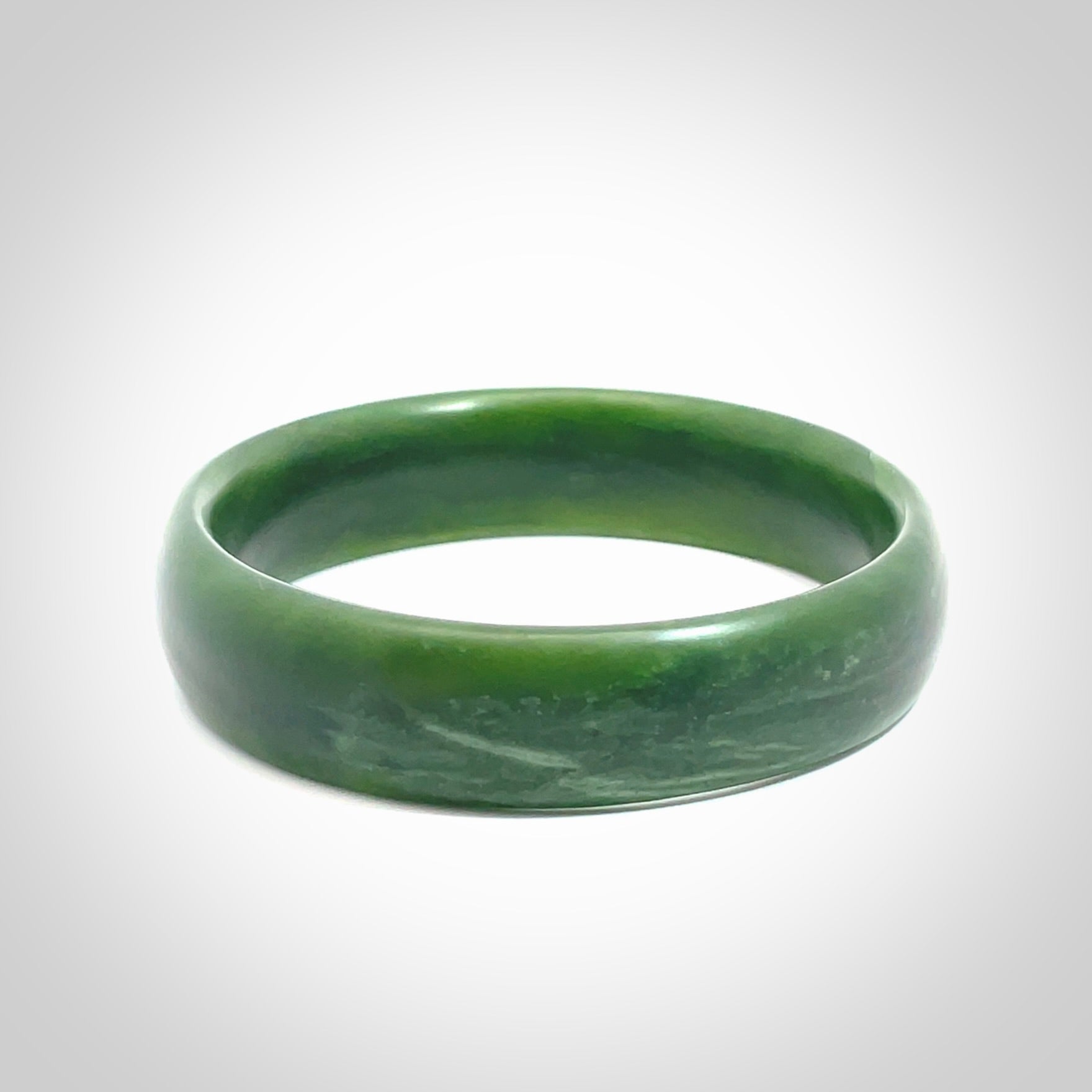 Hand carved New Zealand Jade bangle with matte finish, by Ric Moor. This is a spectacular one off, bracelet hand made in New Zealand from gorgeous Jade. Unique art to wear, delivered in a woven kete pouch. Real New Zealand Jade. Outstanding craftsmanship by New Zealand Master Carver Ric Moor.