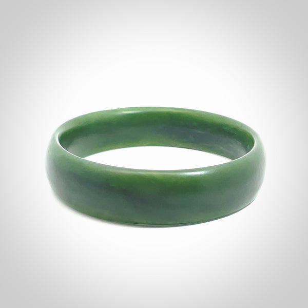 Hand carved New Zealand Jade bangle with matte finish, by Ric Moor. This is a spectacular one off, bracelet hand made in New Zealand from gorgeous Jade. Unique art to wear, delivered in a woven kete pouch. Real New Zealand Jade. Outstanding craftsmanship by New Zealand Master Carver Ric Moor.