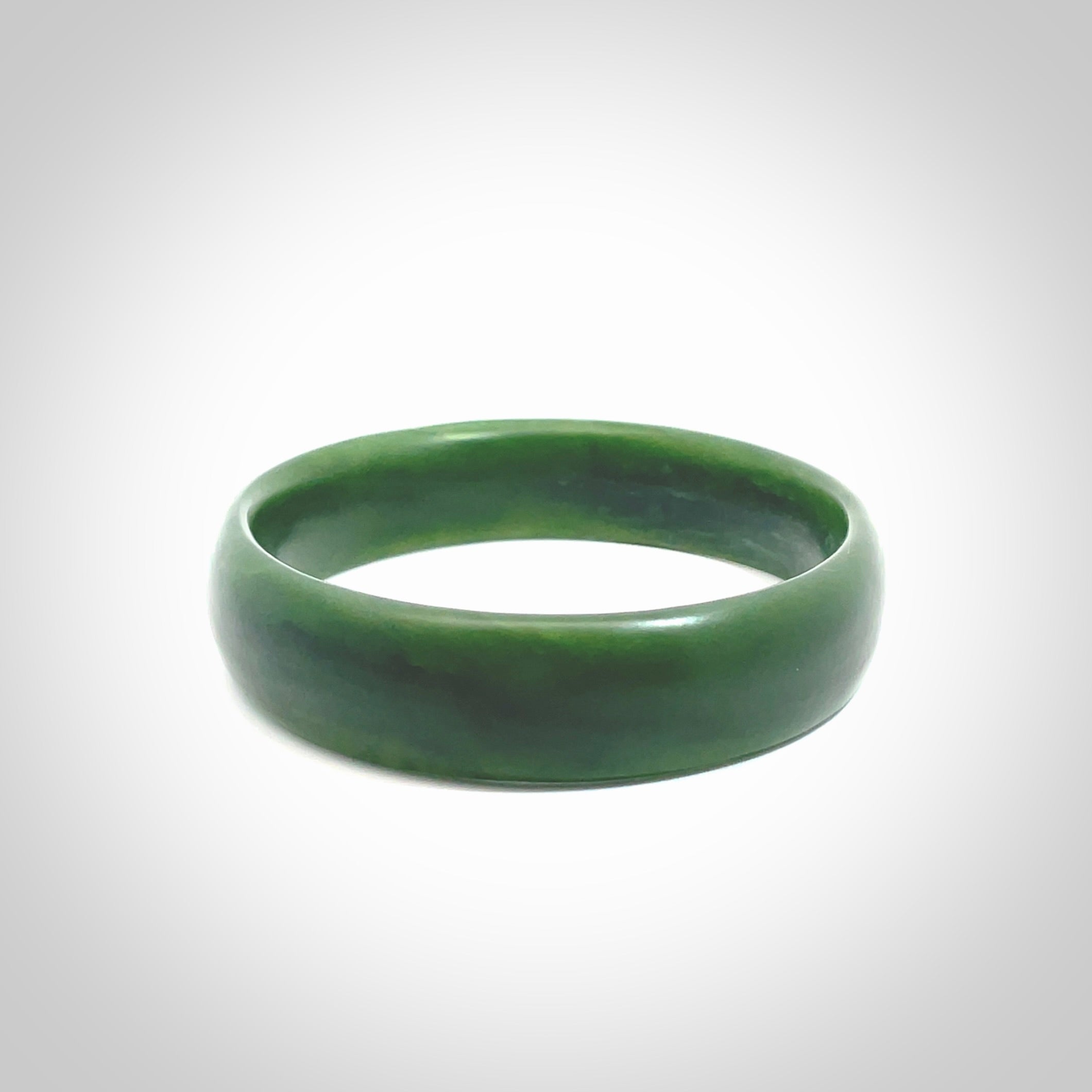 Hand carved New Zealand Jade bangle with matte finish, by Ric Moor. This is a spectacular one off, bracelet hand made in New Zealand from gorgeous Jade. Unique art to wear, delivered in a woven kete pouch. Real New Zealand Jade. Outstanding craftsmanship by New Zealand Master Carver Ric Moor.