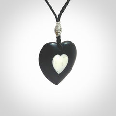 Hand carved black jade heart. Made from Australian black jade. White heart insert is carved from natural bone material. Made by NZ Pacific.