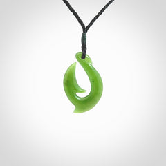 Hand made New Zealand Kahurangi Jade, hook, hei-matau pendant. Hand carved fish hook made from New Zealand jade. Carved by Ross Crump. Provided with adjustable black cord.