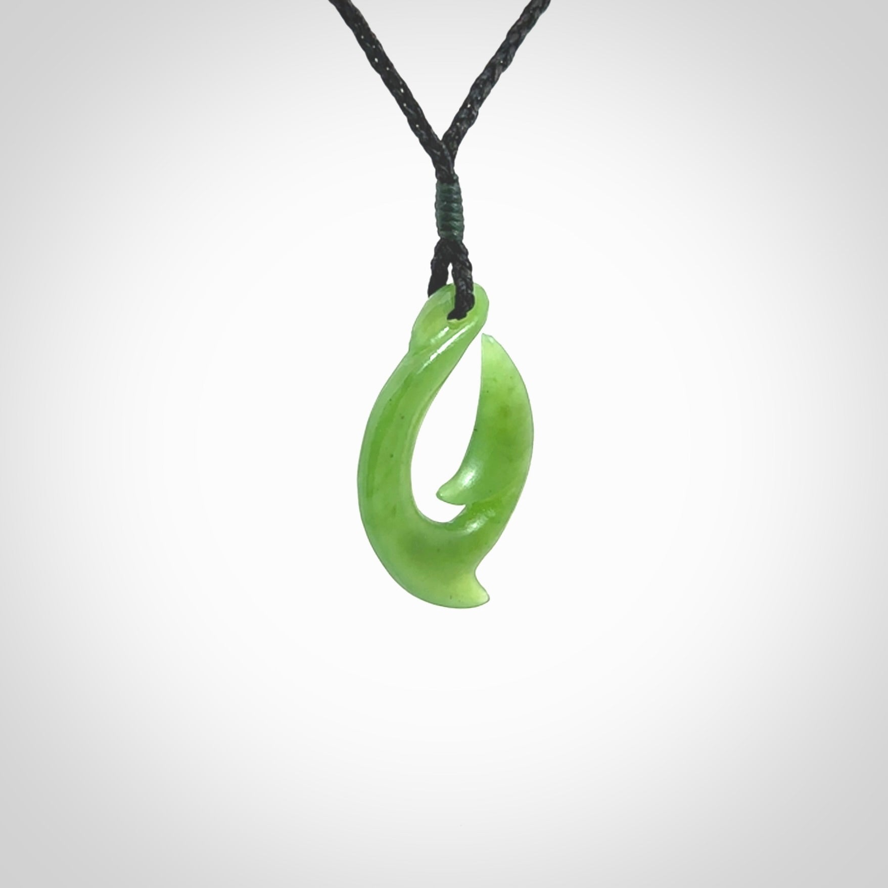 Hand made New Zealand Kahurangi Jade, hook, hei-matau pendant. Hand carved fish hook made from New Zealand jade. Carved by Ross Crump. Provided with adjustable black cord.