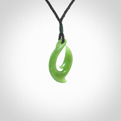 Hand made New Zealand Kahurangi Jade, hook, hei-matau pendant. Hand carved fish hook made from New Zealand jade. Carved by Ross Crump. Provided with adjustable black cord.