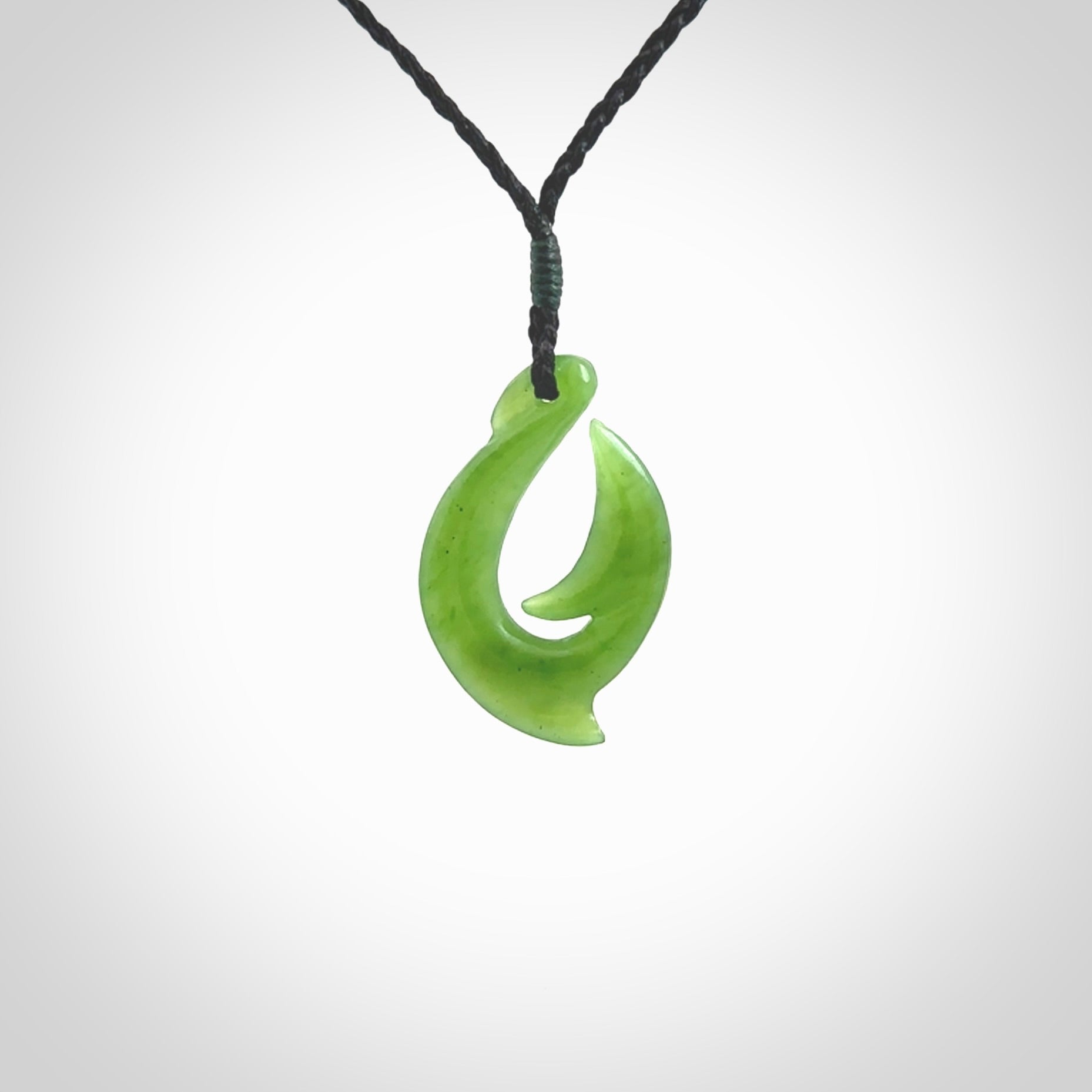 Hand made New Zealand Kahurangi Jade, hook, hei-matau pendant. Hand carved fish hook made from New Zealand jade. Carved by Ross Crump. Provided with adjustable black cord.