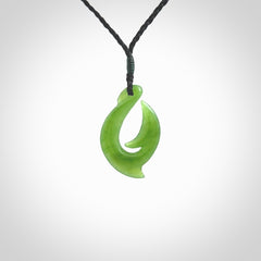 Hand made New Zealand Kahurangi Jade, hook, hei-matau pendant. Hand carved fish hook made from New Zealand jade. Carved by Ross Crump. Provided with adjustable black cord.