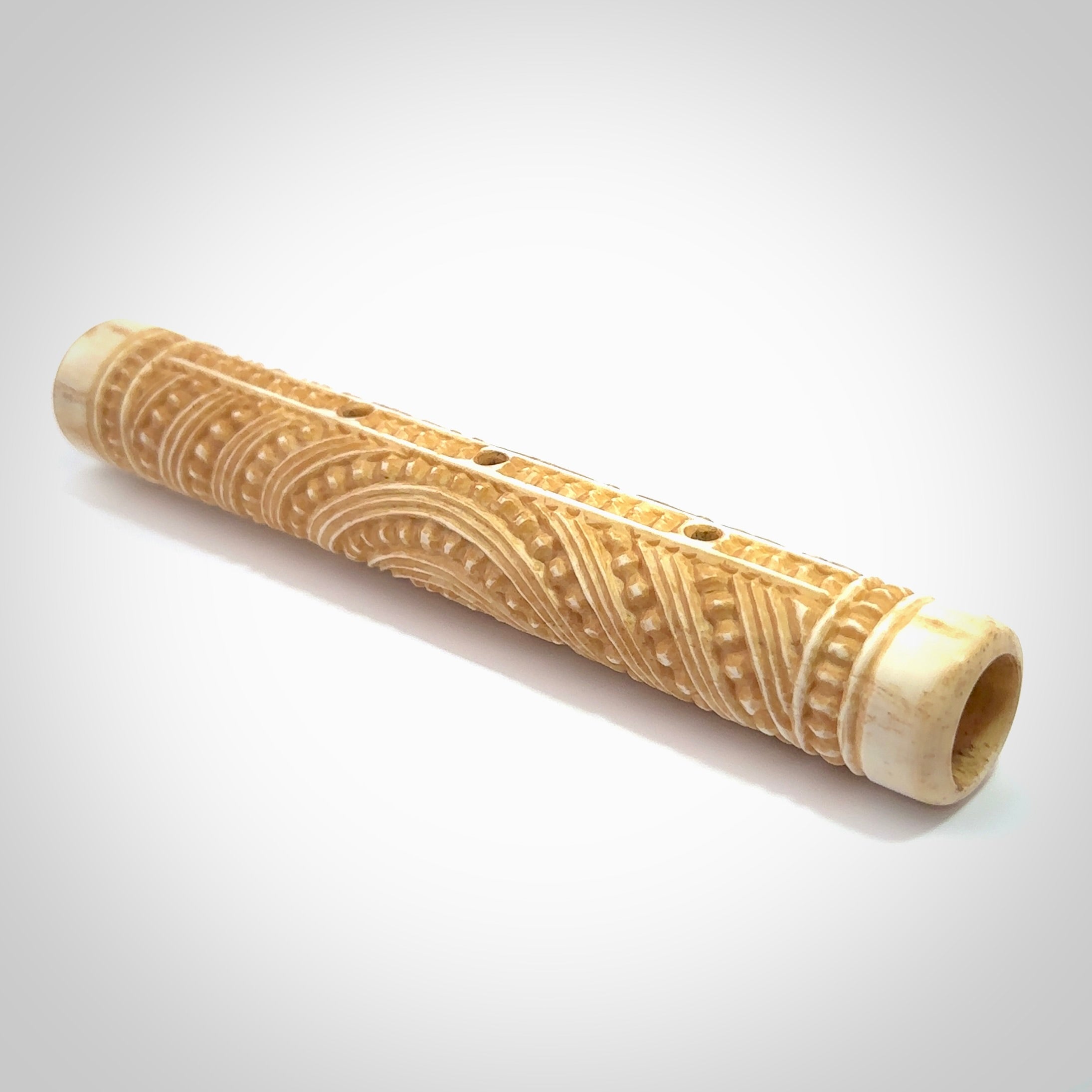 A traditional hand carved Māori flute. This piece is made from bone and is a fully functioning musical instrument and can be played. Beautiful ethnic art hand made by NZ Pacific.