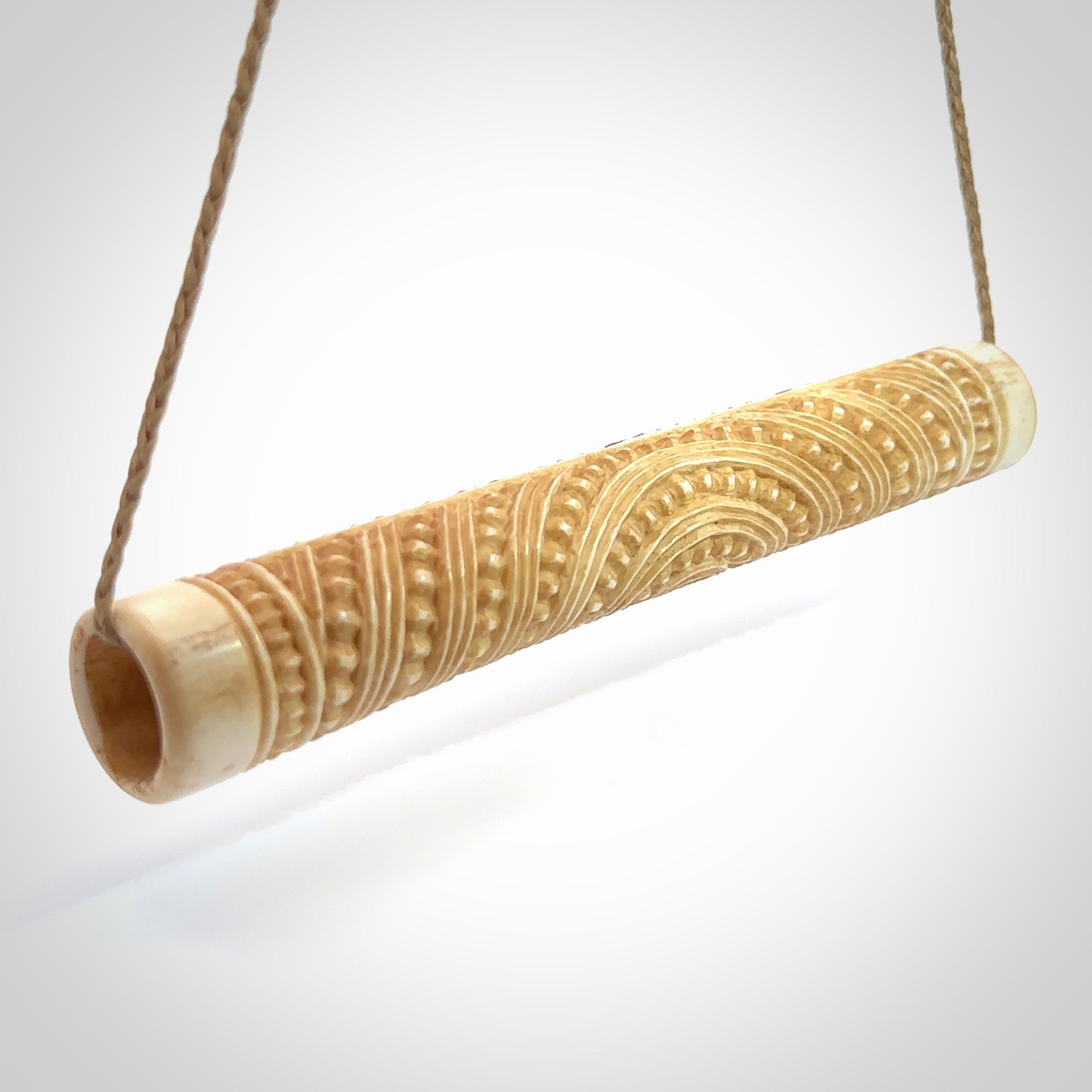 A traditional hand carved Māori flute. This piece is made from bone and is a fully functioning musical instrument and can be played. Beautiful ethnic art hand made by NZ Pacific.