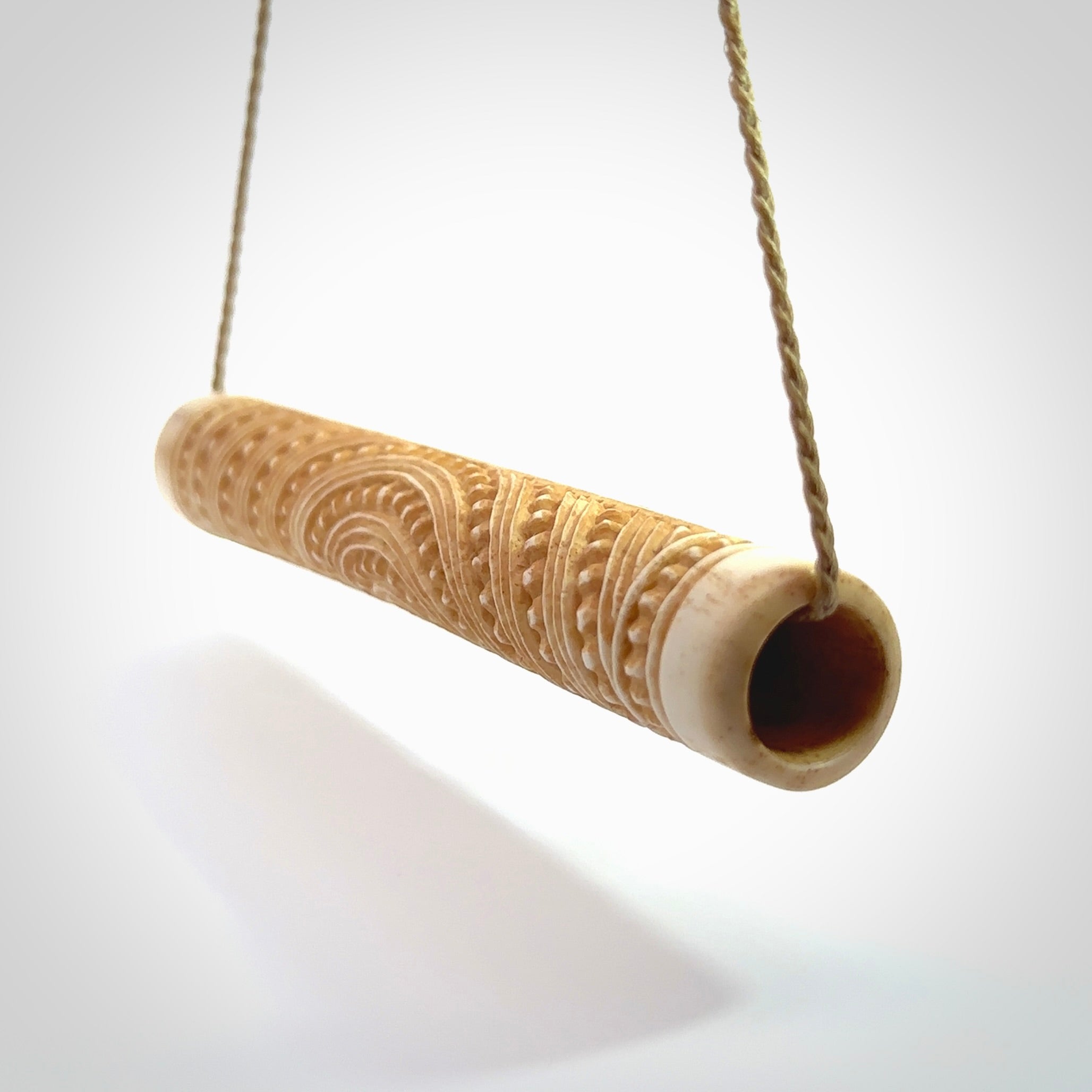 A traditional hand carved Māori flute. This piece is made from bone and is a fully functioning musical instrument and can be played. Beautiful ethnic art hand made by NZ Pacific.