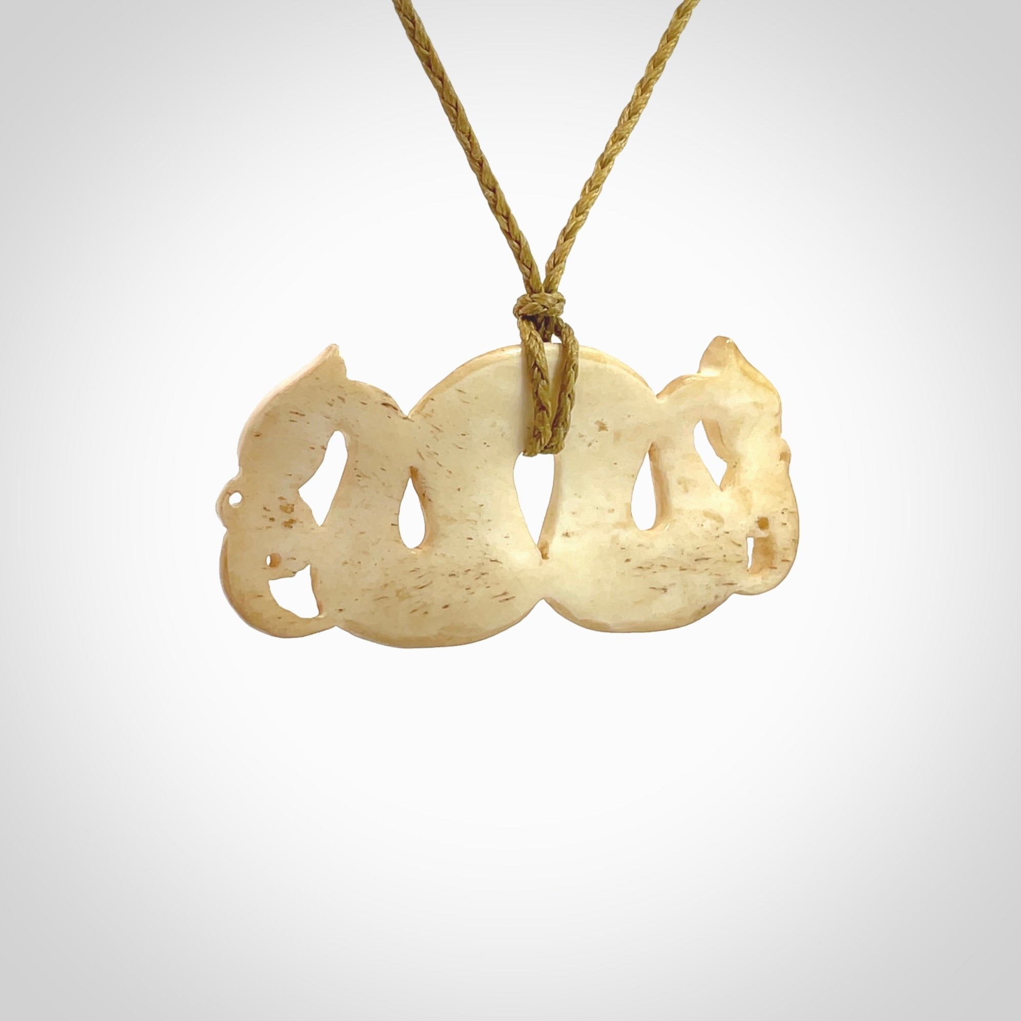 This is a unique double manaia, pekapeka, hand carved bone pendant from cow bone. The cord is sahara tan and is length adjustable. This is delivered to you with Express Courier. The eyes are made from Paua shell.