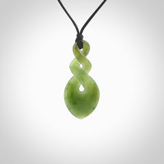 Hand carved New Zealand jade twist pendant. Carved in New Zealand by NZ Pacific. Unique double twist jewellery for sale online. Provided with an adjustable black cord.