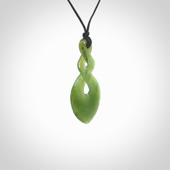 Hand carved New Zealand jade twist pendant. Carved in New Zealand by NZ Pacific. Unique double twist jewellery for sale online. Provided with an adjustable black cord.