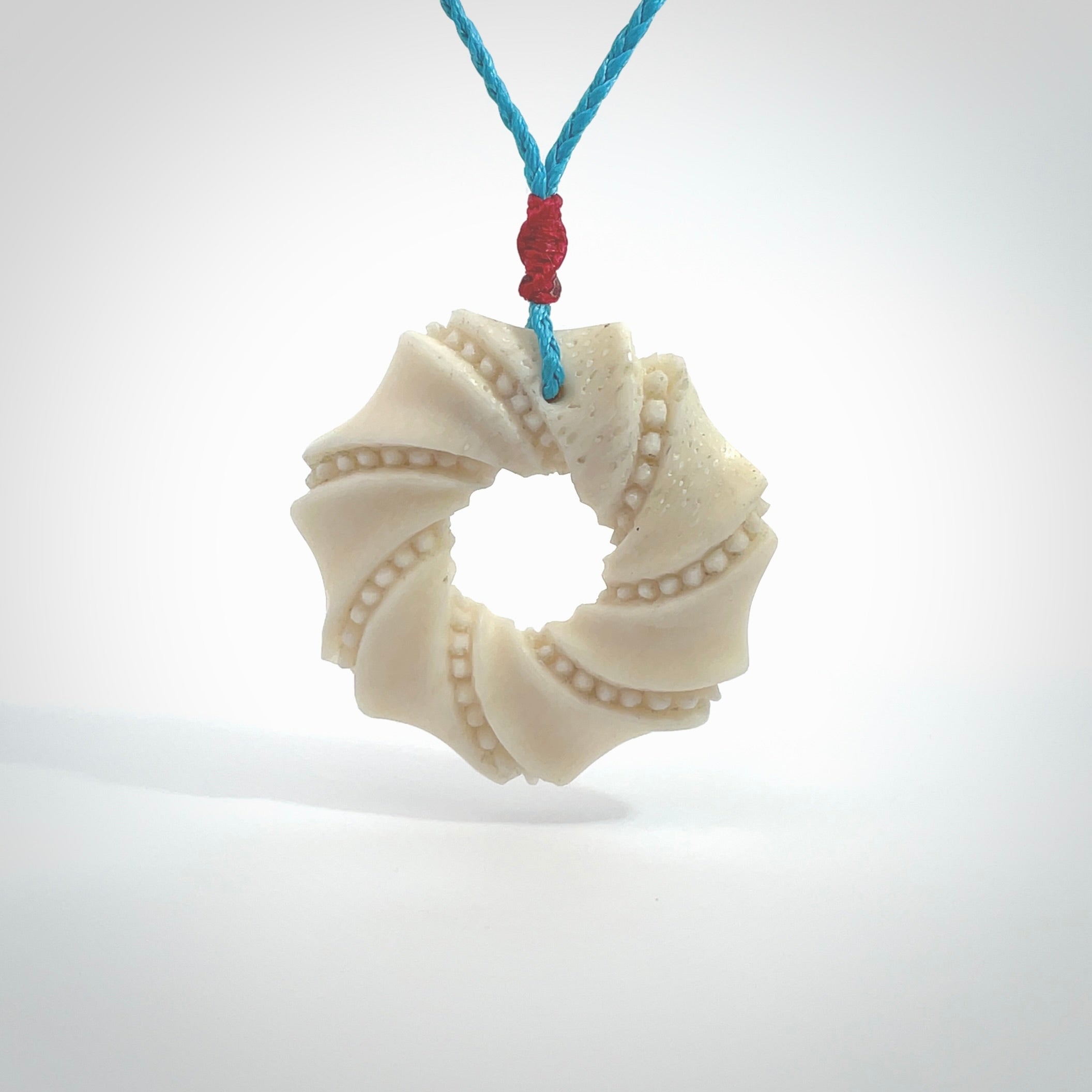 A hand carved masterpiece. A beautiful contemporary pendant carved from bone by Yuri Terenyi for NZ Pacific. This is a true piece of wearable art which is collectible. A one-off masterpiece and quite unique. Provided with an adjustable paradise blue cord and packaged in a woven kete pouch.