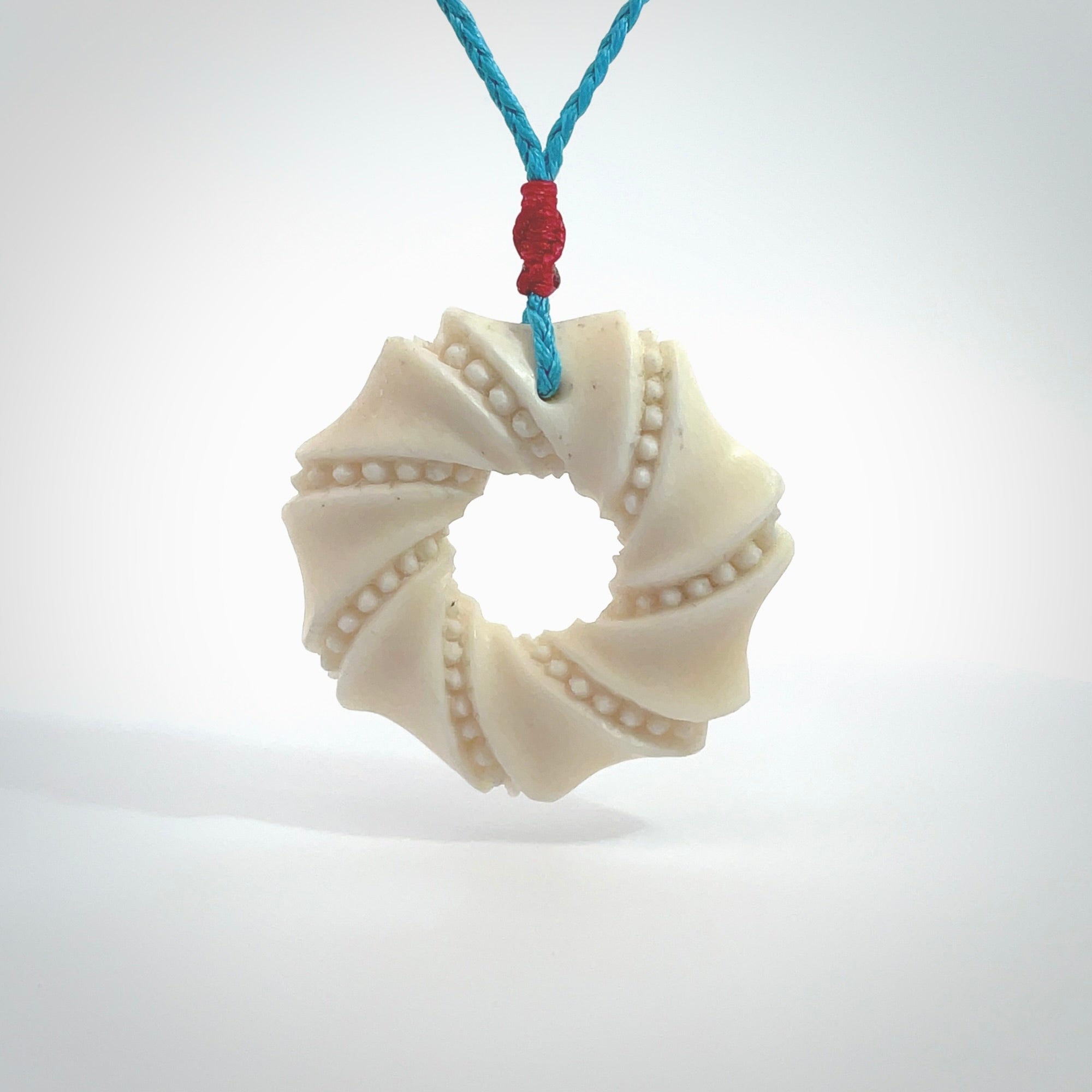 A hand carved masterpiece. A beautiful contemporary pendant carved from bone by Yuri Terenyi for NZ Pacific. This is a true piece of wearable art which is collectible. A one-off masterpiece and quite unique. Provided with an adjustable paradise blue cord and packaged in a woven kete pouch.