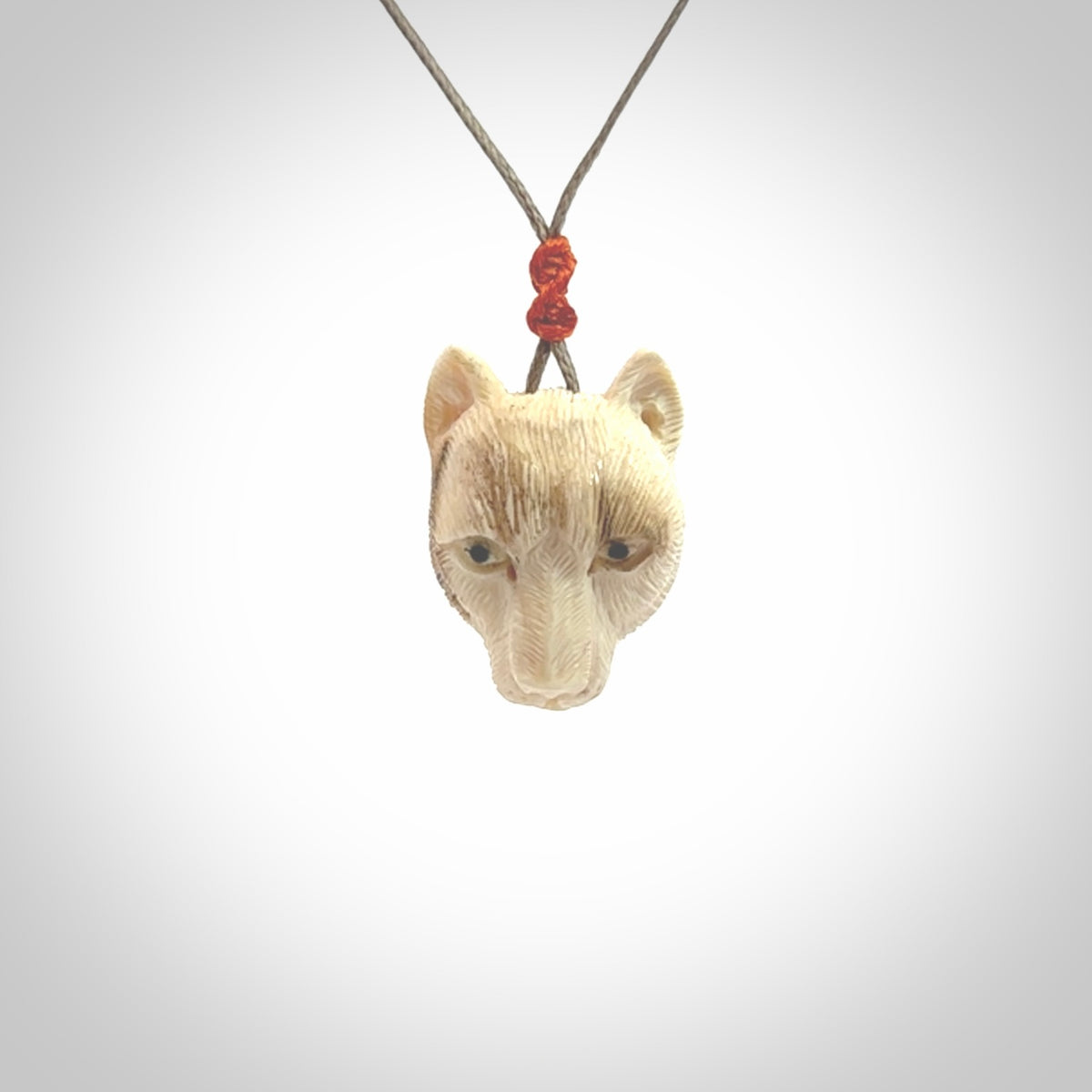 This pendant is a hand carved puma. We've carved this from a lovely piece of woolly mammoth tusk and we provide it with a hand plaited cord. Shipping is free worldwide.