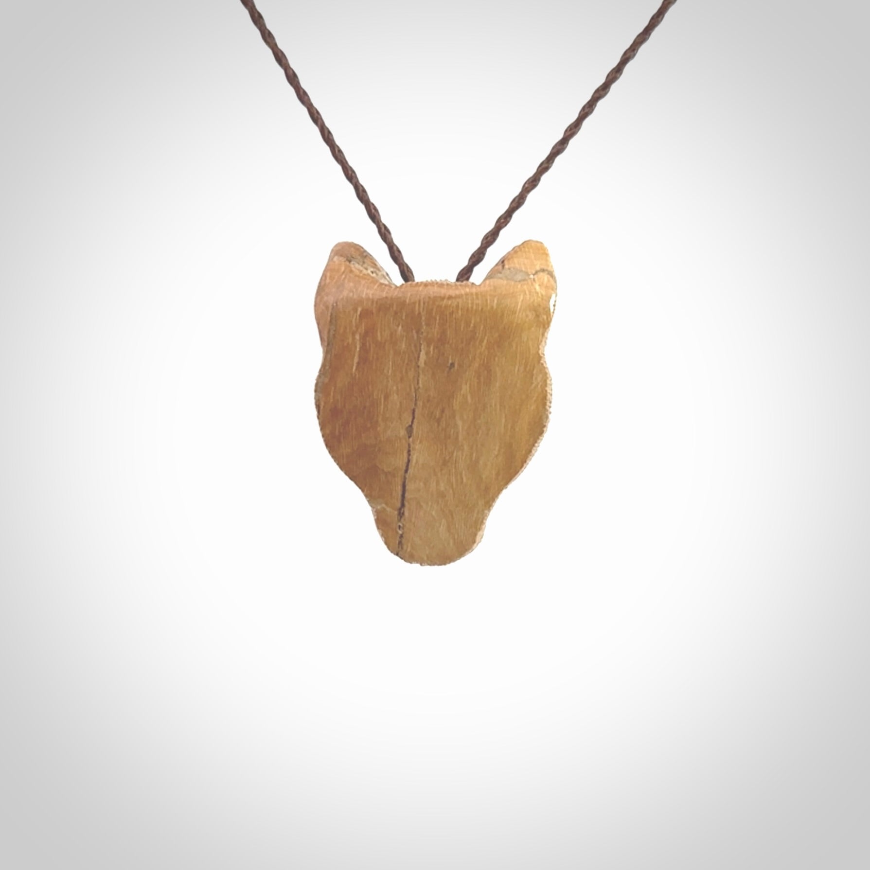 This pendant is a hand carved puma. We've carved this from a lovely piece of woolly mammoth tusk and we provide it with a hand plaited cord. Shipping is free worldwide.