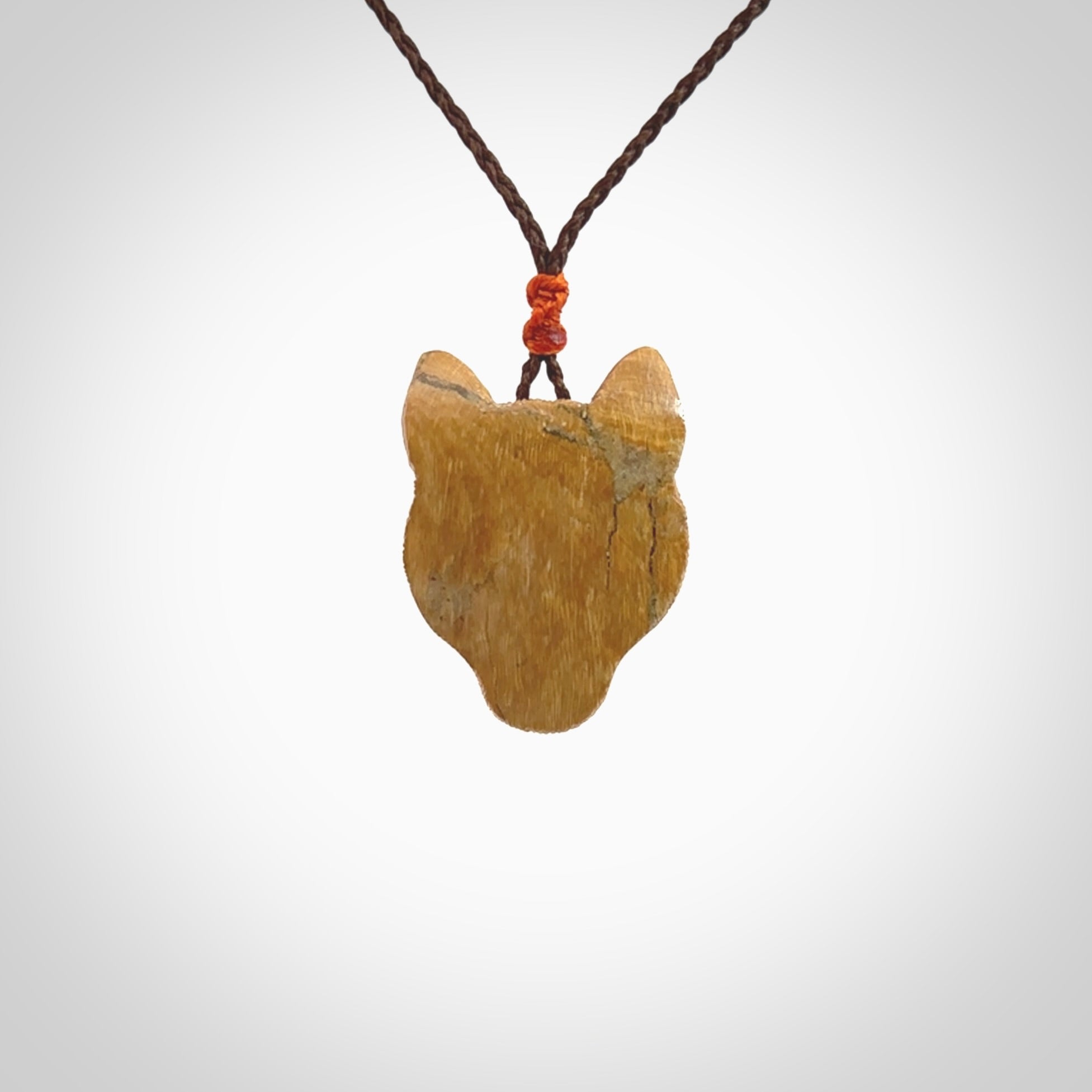 This pendant is a hand carved puma. We've carved this from a lovely piece of woolly mammoth tusk and we provide it with a hand plaited cord. Shipping is free worldwide.