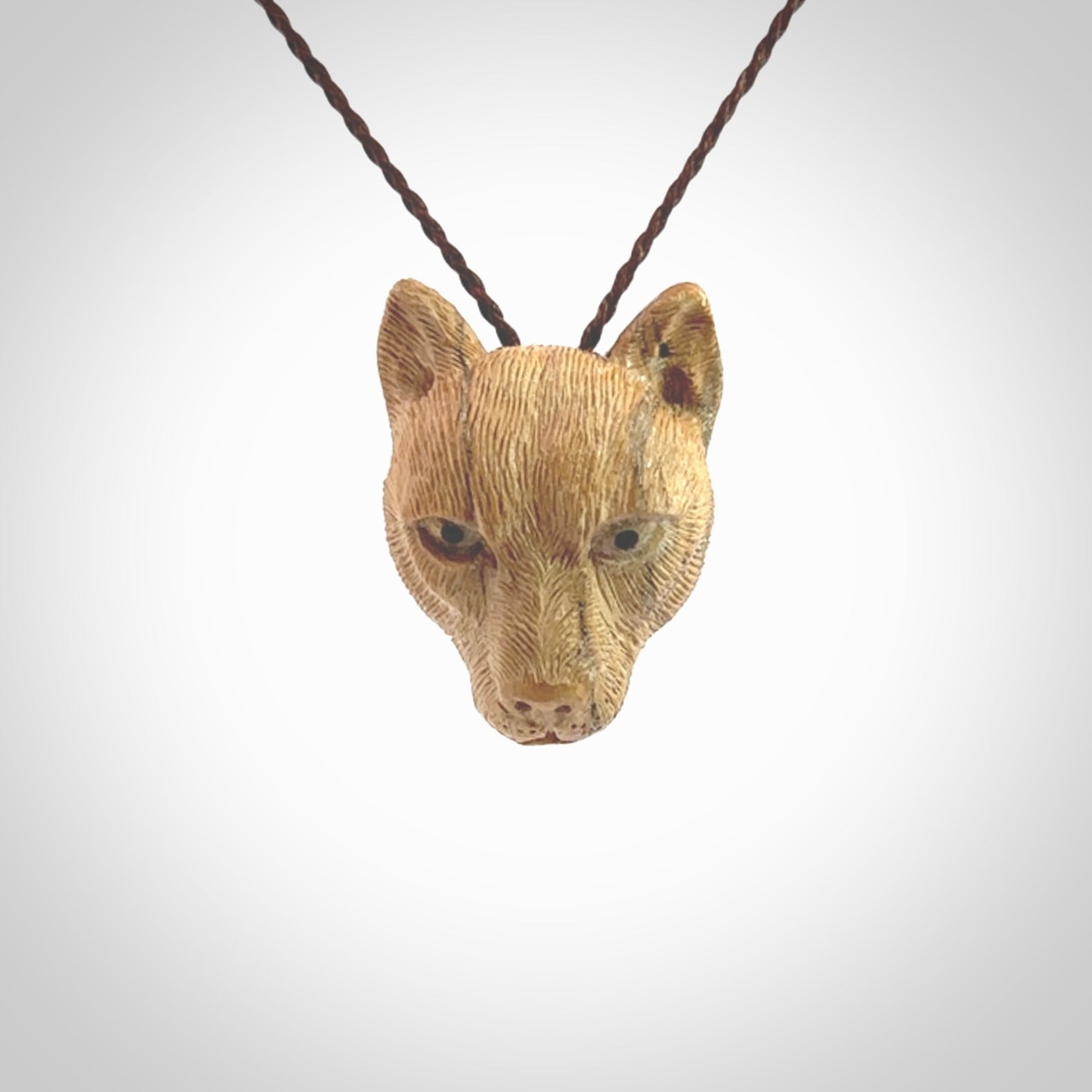 This pendant is a hand carved puma. We've carved this from a lovely piece of woolly mammoth tusk and we provide it with a hand plaited cord. Shipping is free worldwide.