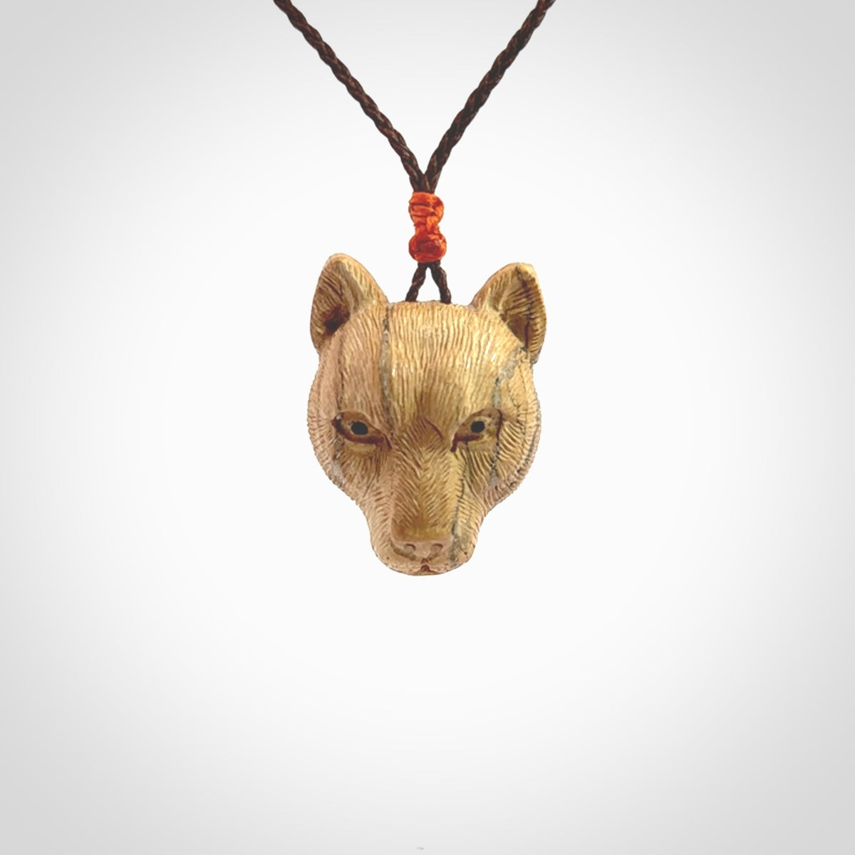 This pendant is a hand carved puma. We've carved this from a lovely piece of woolly mammoth tusk and we provide it with a hand plaited cord. Shipping is free worldwide.