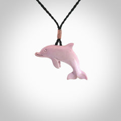 This is a hand carved dolphin pendant made from a gorgeous and striking piece of Pink Opal stone. This is a superbly carved and very unique dolphin necklace. For sale online from NZ Pacific. Delivered with adjustable cord.