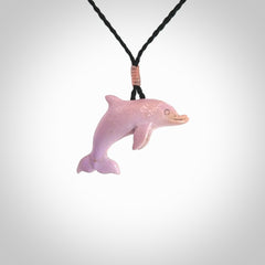 This is a hand carved dolphin pendant made from a gorgeous and striking piece of Pink Opal stone. This is a superbly carved and very unique dolphin necklace. For sale online from NZ Pacific. Delivered with adjustable cord.