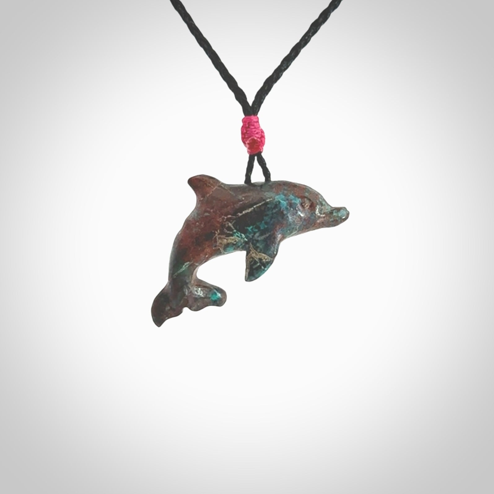 This is a hand carved dolphin pendant made from a gorgeous and striking piece of African Turquoise stone. This is a superbly carved and very unique dolphin necklace. For sale online from NZ Pacific. Delivered with adjustable cord.