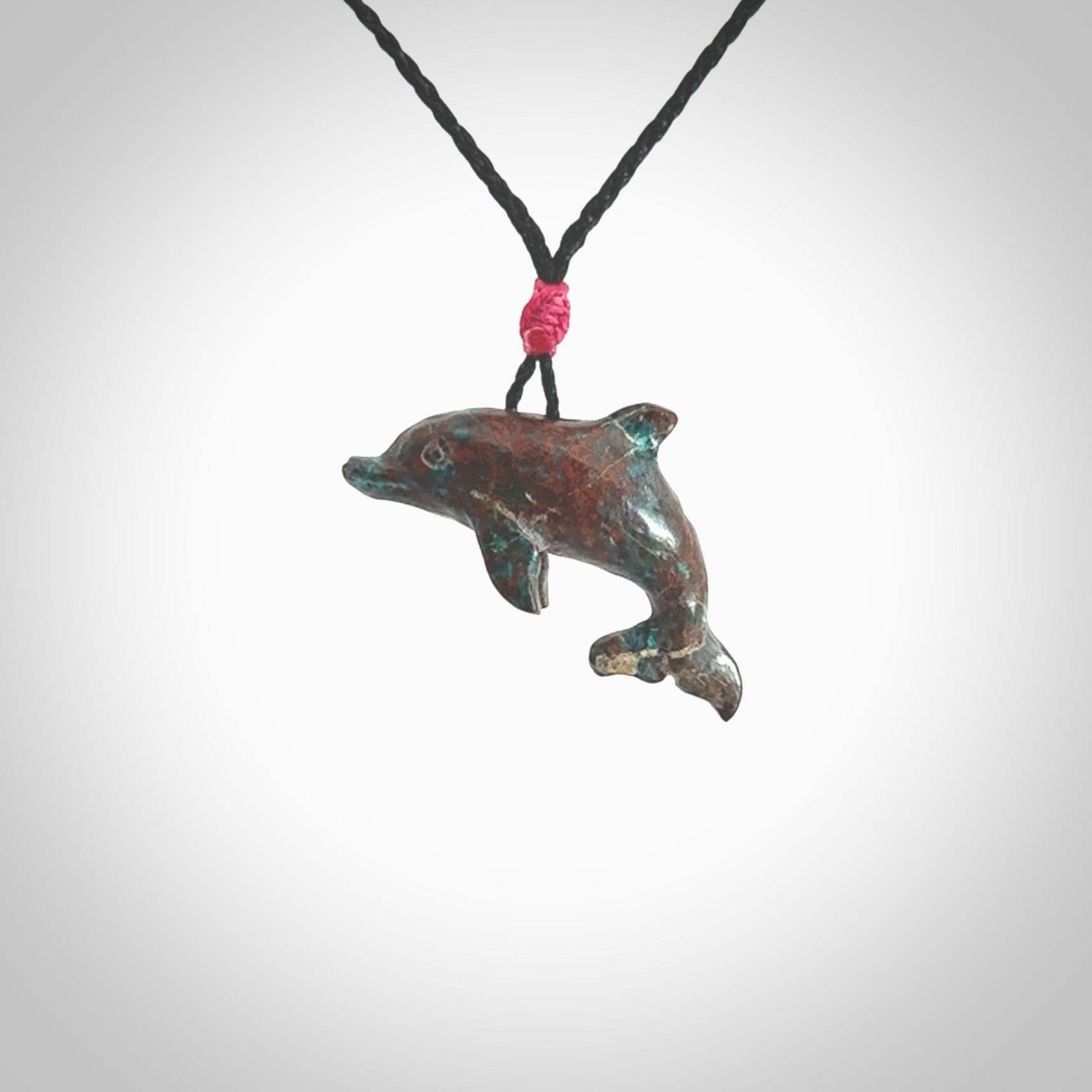 This is a hand carved dolphin pendant made from a gorgeous and striking piece of African Turquoise stone. This is a superbly carved and very unique dolphin necklace. For sale online from NZ Pacific. Delivered with adjustable cord.