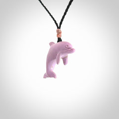 This is a hand carved dolphin pendant made from a gorgeous and striking piece of Pink Opal stone. This is a superbly carved and very unique dolphin necklace. For sale online from NZ Pacific. Delivered with adjustable cord.