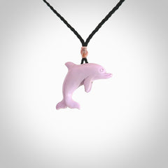 This is a hand carved dolphin pendant made from a gorgeous and striking piece of Pink Opal stone. This is a superbly carved and very unique dolphin necklace. For sale online from NZ Pacific. Delivered with adjustable cord.