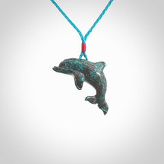 This is a hand carved dolphin pendant made from a gorgeous and striking piece of African Turquoise stone. This is a superbly carved and very unique dolphin necklace. For sale online from NZ Pacific. Delivered with adjustable cord.